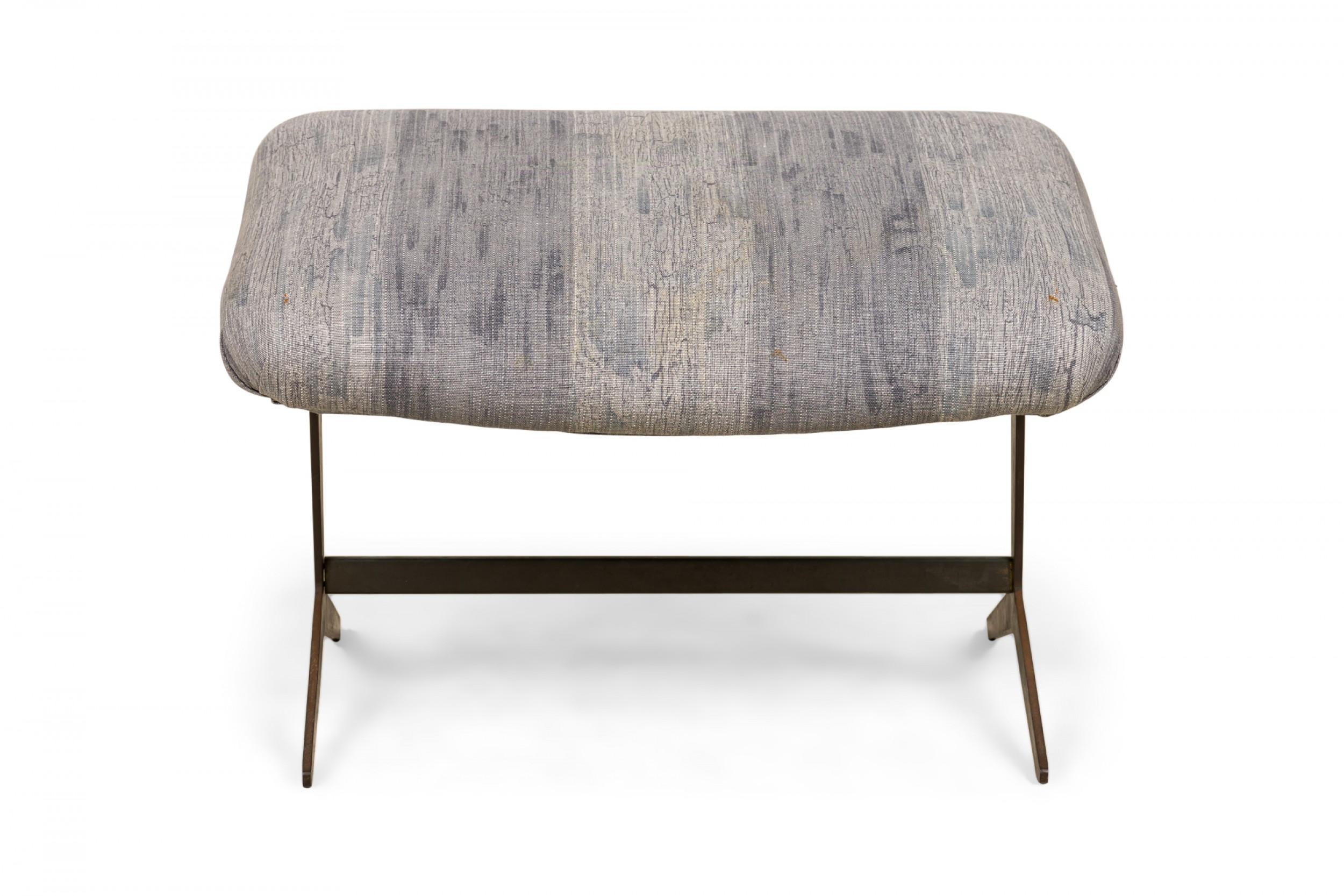 American mid-century scoop chair footstool with a faintly striped grey upholstered rectangular top resting on a brass stretcher base. (SELIG)