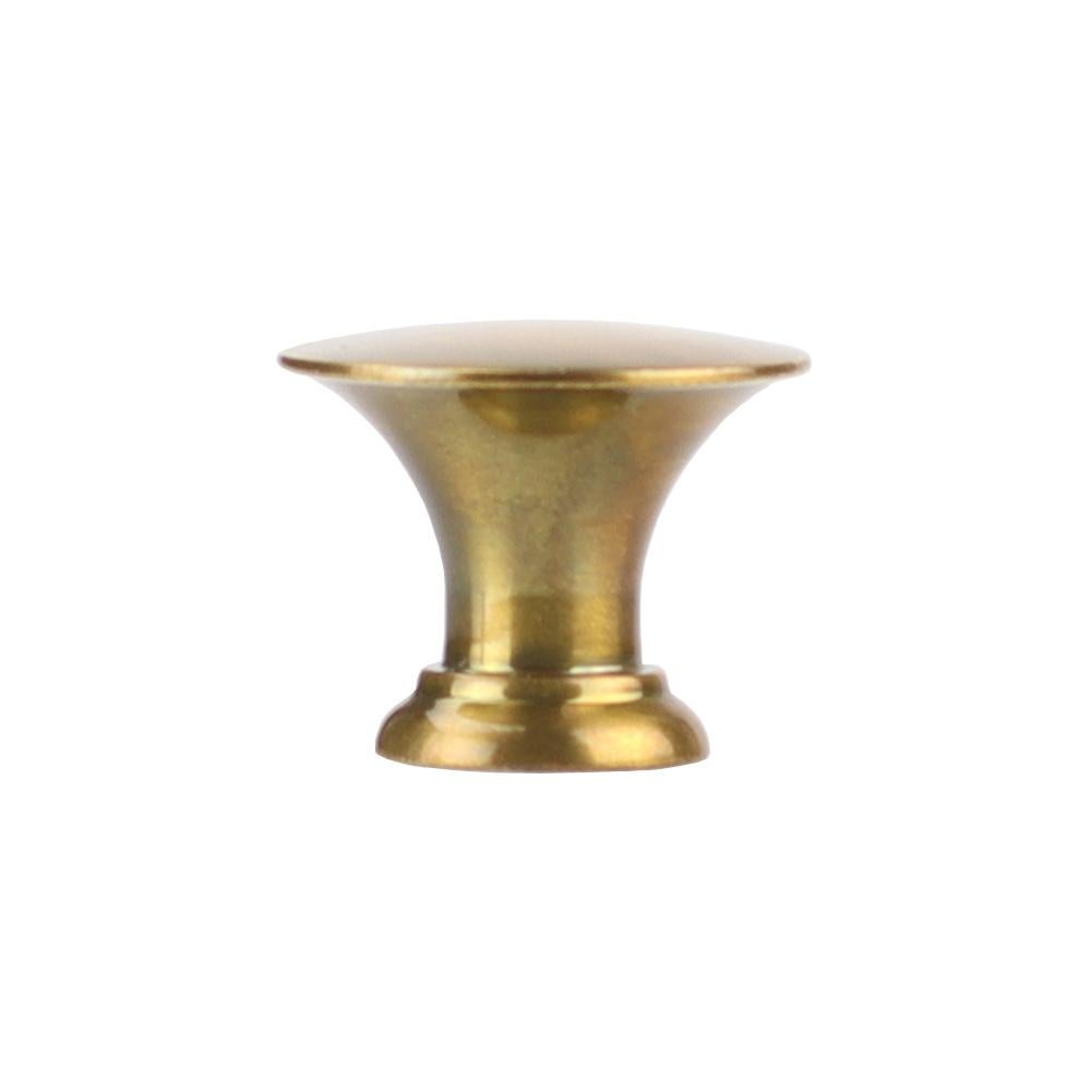 A distinctive, button-shaped pull. The flared profile springs to a slightly cambered top. Fingers easily find their place between the perfectly round face and a full, filleted rose. 

Metal finishes available in burnished brass or burnished nickel.