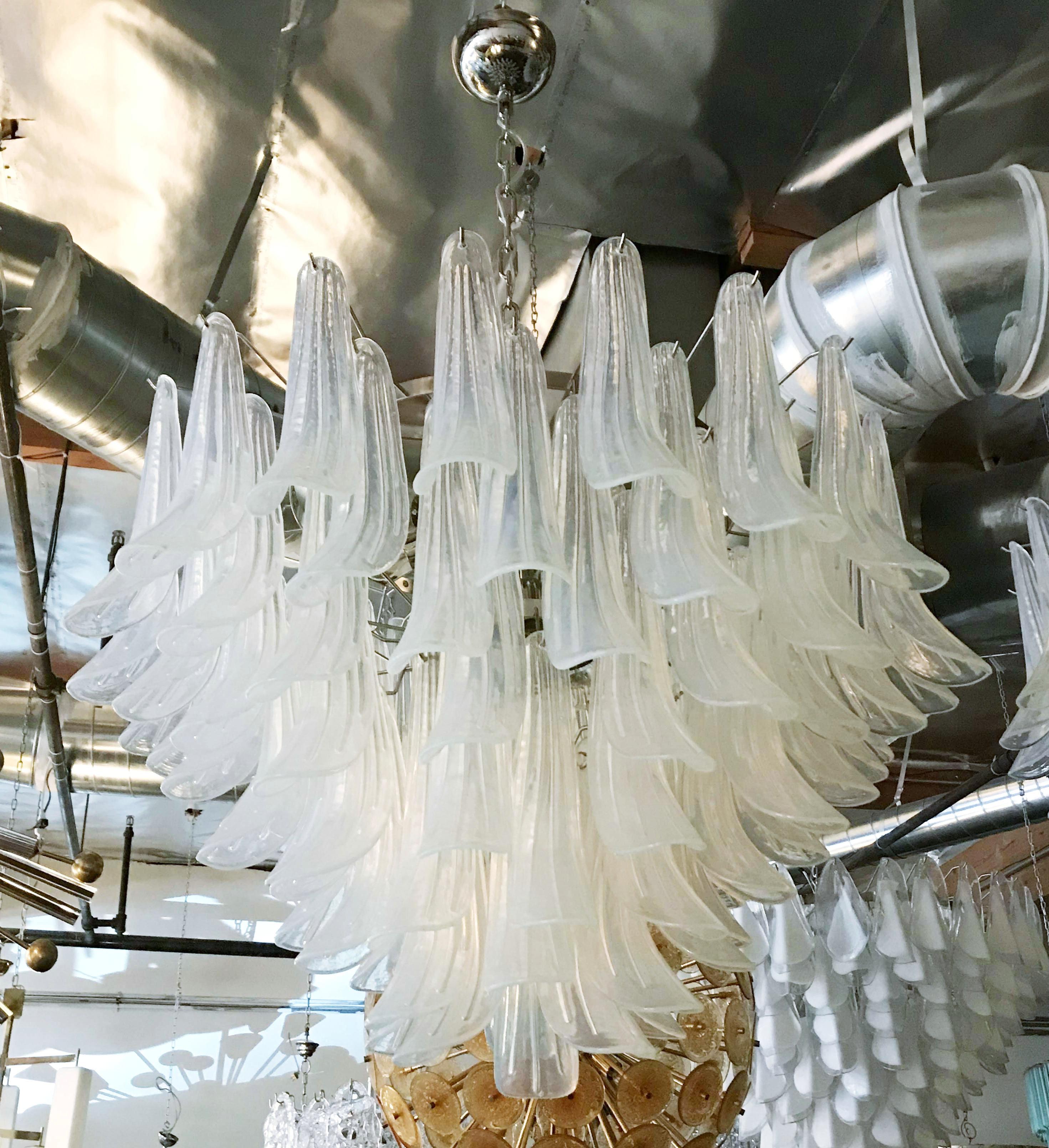 Italian chandelier with opaline Murano glasses hand blown into beautiful small saddles or leaves, mounted on nickel frame by Fabio Ltd / Made in Italy
13 lights / E26 or E27 type / max 60W each
Measures: Diameter 36 inches, height 25 inches plus