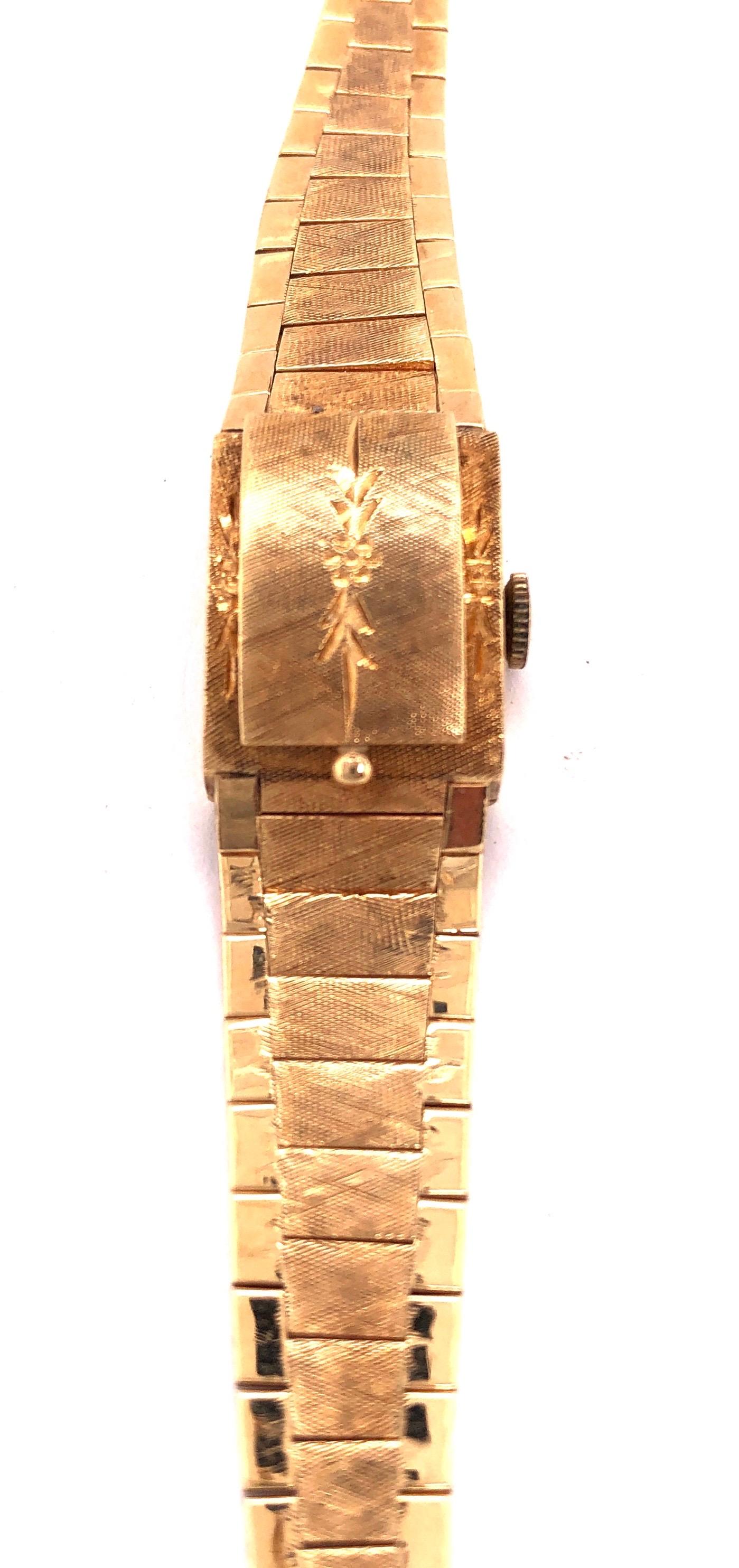 Mid Century Modern Sellita Ladies 14 Karat Yellow Gold Bracelet Wrist Watch 21.9 Grams Swiss 17 Jewels. 6.5 inch. This bracelet wrist watch has a hidden face under an etched cover. Art Deco in Style 21.9 grams. 

Sellita is a Swiss movement