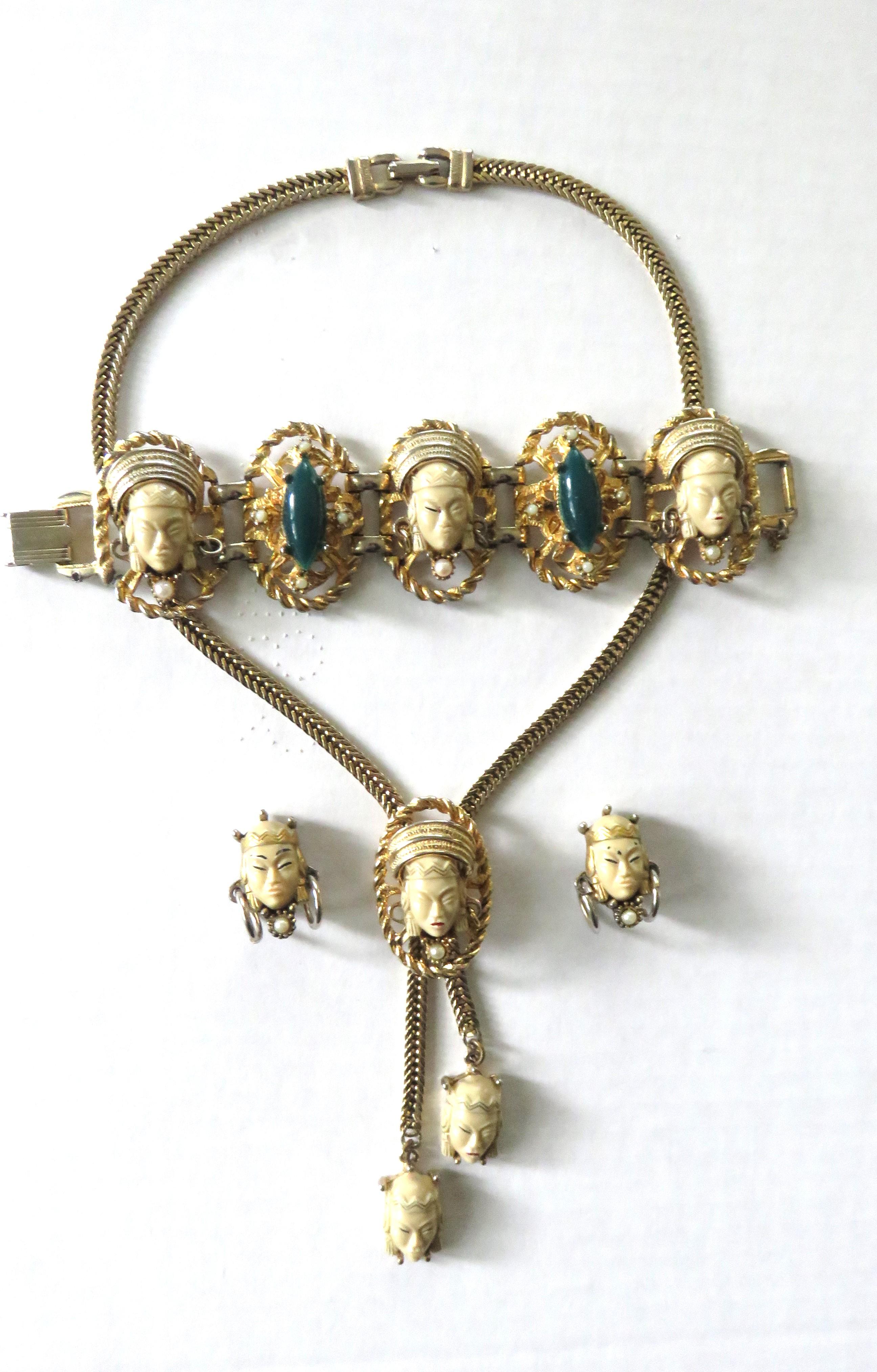 This is a fabulous 4 piece brass and lucite set from Selro Selini (unsigned) including a necklace, earrings and bracelet. It includes an adjustable bolo style necklace with a central face plus one on each end of the chain and a back fold over clasp
