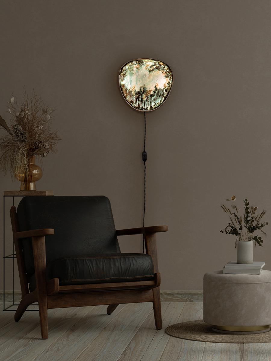 “Selvatica” is a wall lamp with a LED backlight, conceived as an external window to connect you to nature even in those places, where it is not actually present. Its front panel is made of painted paper  with subsequent material interventions on the