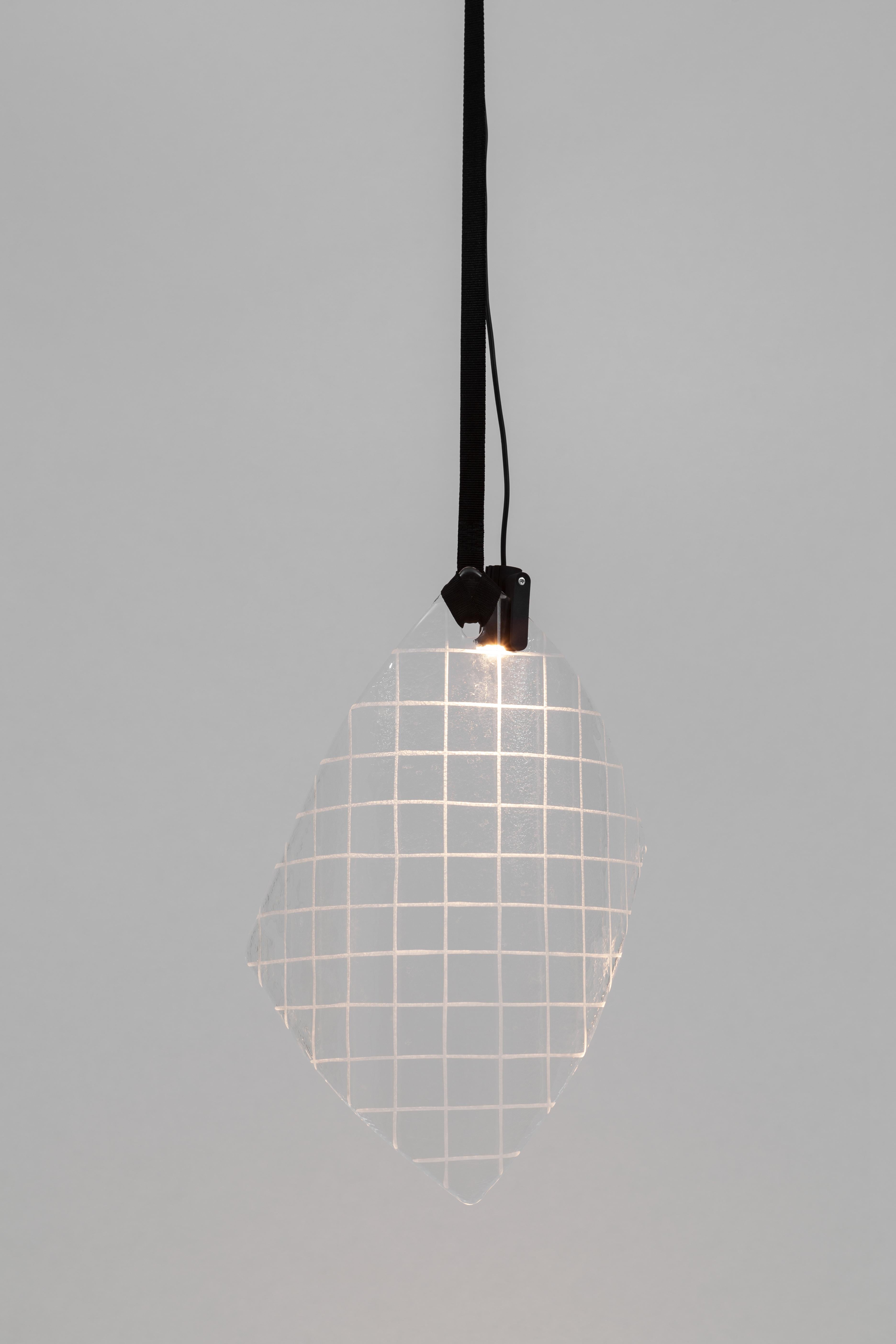 In Lace, Zaven takes inspiration from the longstanding tradition of Venetian lace-making. The resulting lamp is a hanging glass doily lace, whose original flattened shape has been bent down as an effect of gravity and the glass’s own weight. A