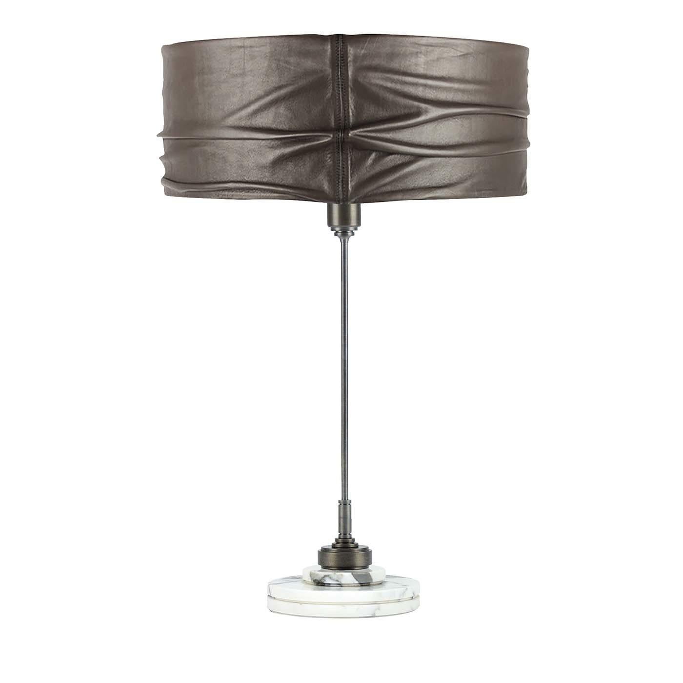 Showcasing an exquisite combination of materials and textures, this table lamp features a round base of Carrara Arabescato marble whose exquisite pattern of swirling whites and grays complements the eye-catching ruched texture of the gray leather