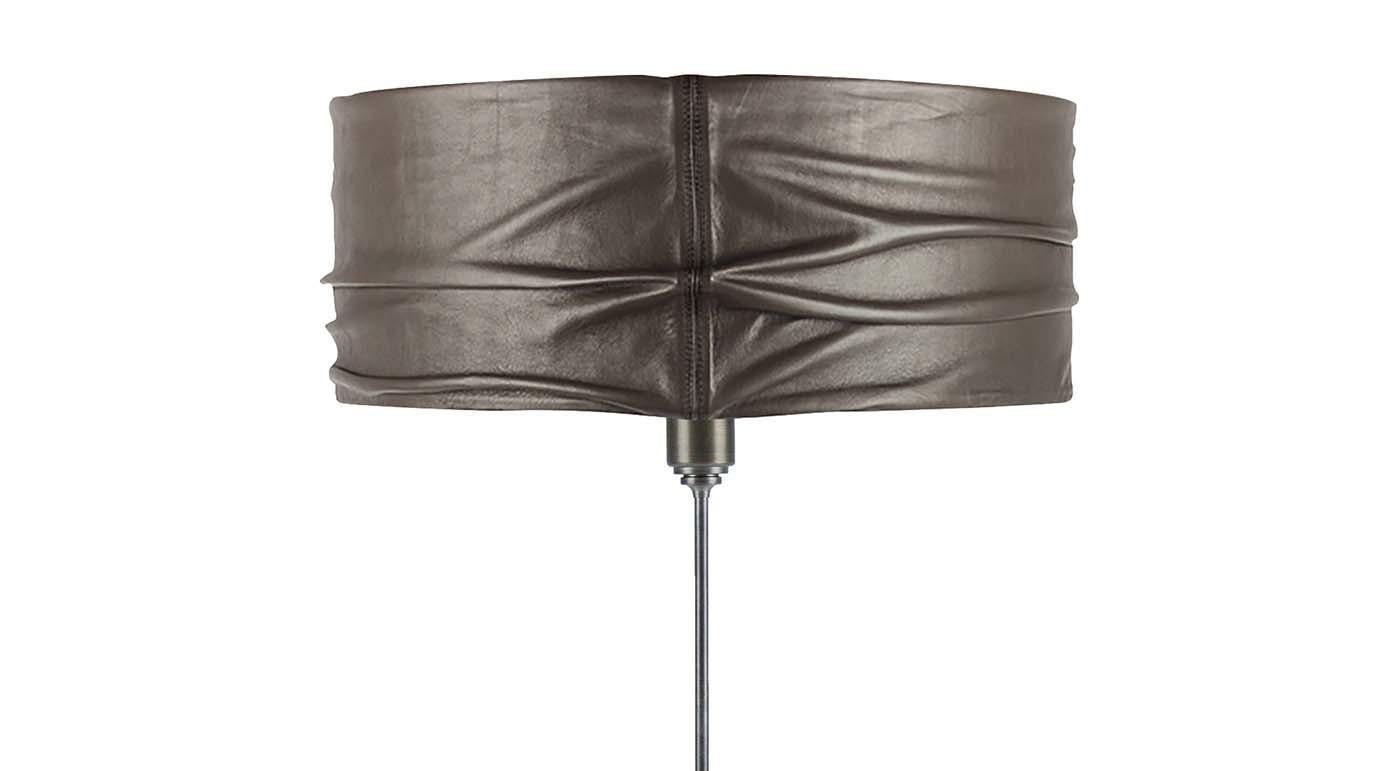 Rising from a solid marble base with a clean-lined silhouette, this table lamp is entirely handcrafted from skilled artisans. The structure is entirely made of steel and functions as a perfect, understated support for the captivating drum lampshade