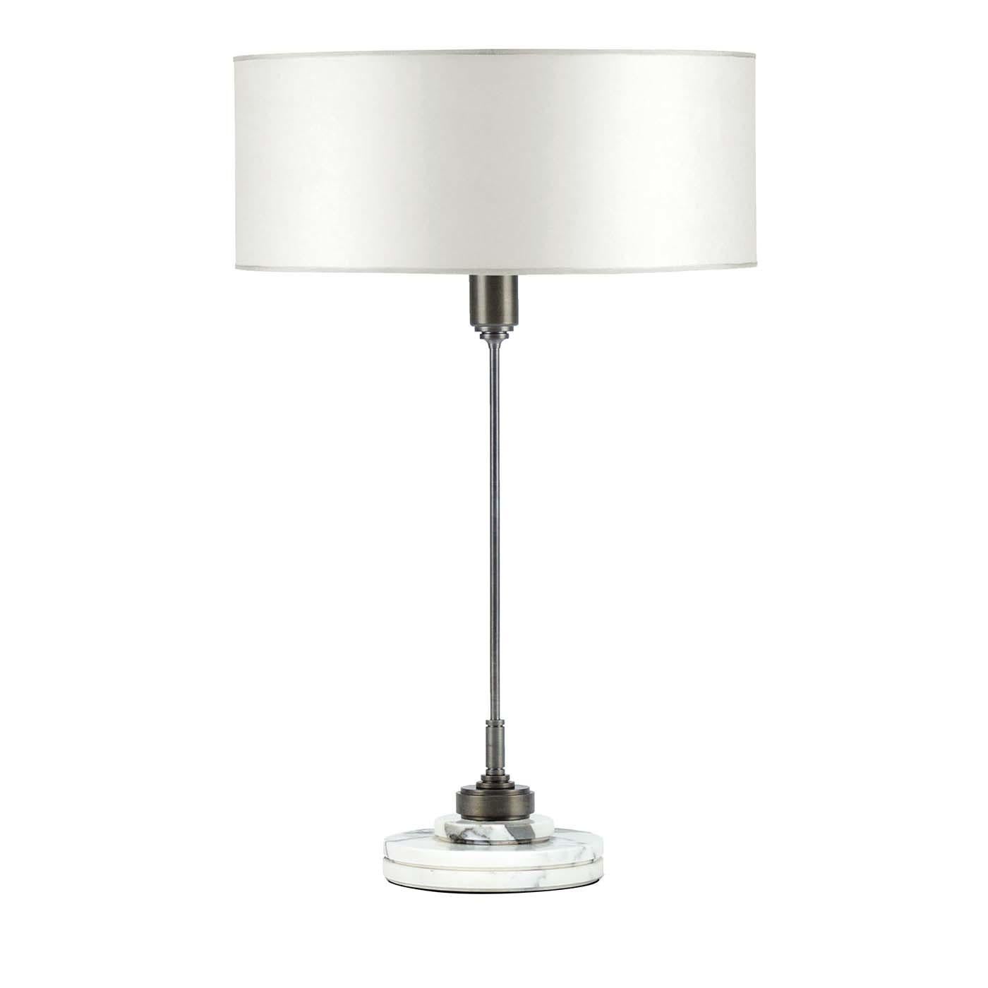 Understated elegance and versatility define this table lamp that will become the protagonist in any room with a Minimalist, industrial-chic decor. This superbly handcrafted piece showcases a bold drum shade made of white parchment supported by a