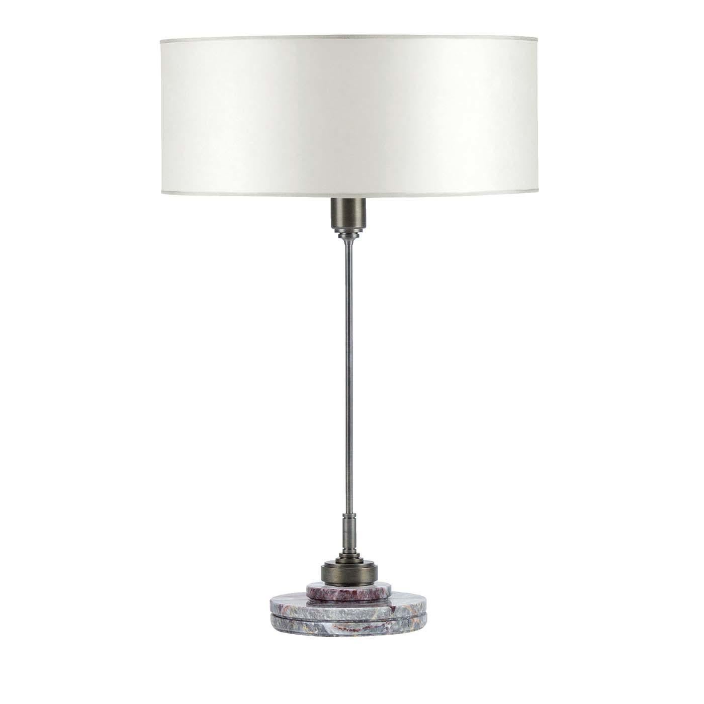 Stunning in its simplicity, this table lamp is a perfect balance of form and style. Meticulously handcrafted by skilled artisans, this piece features a steel body with a thin rod supported by a round base of SalomÃ marble whose dramatic lilac,