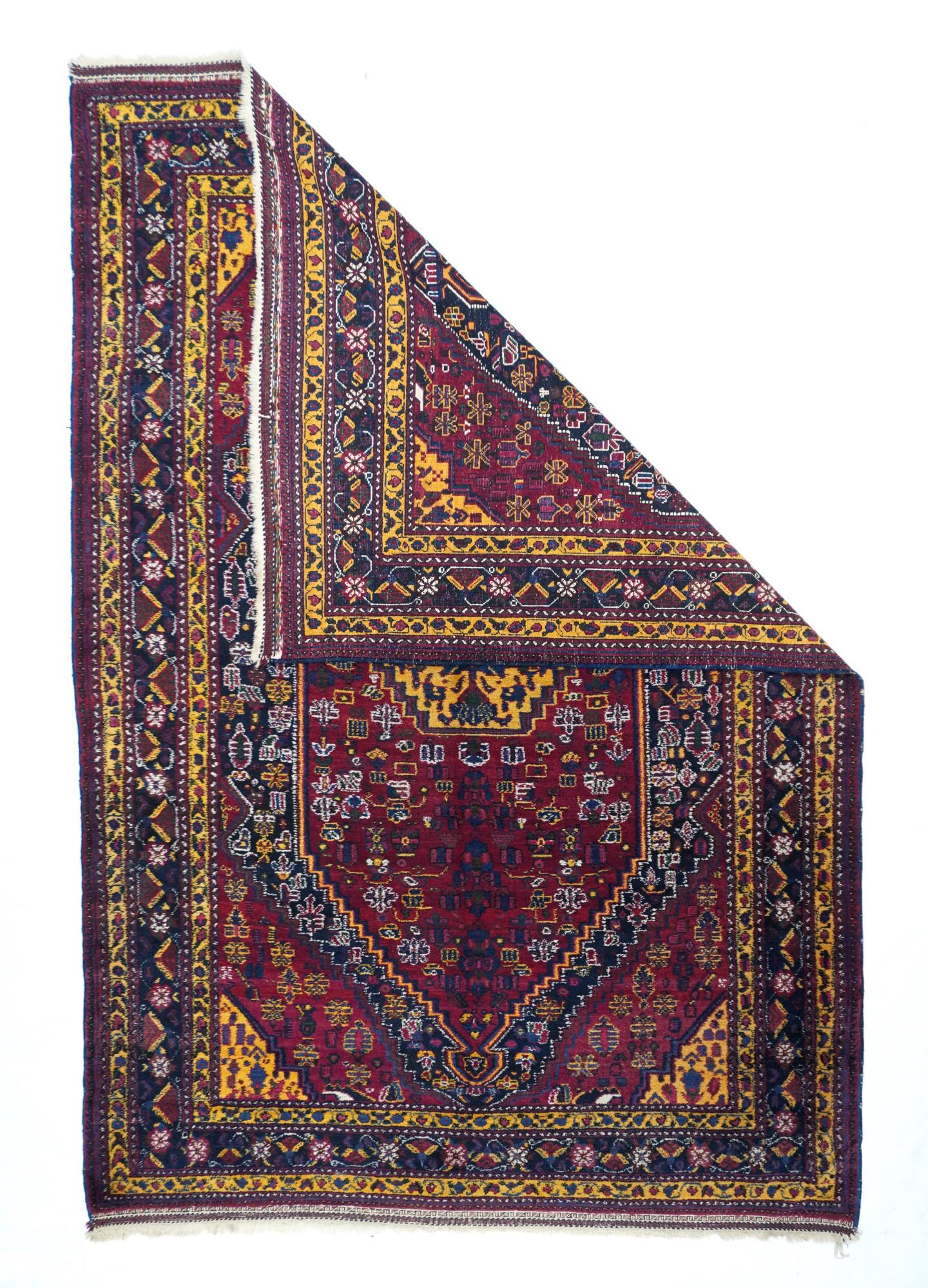 An attractive Persian tribal rug with an outstanding banana yellow in the stepped central medallion, the triangular corners, the minor borders, and scattered details everywhere, but where is it from?  The red subfield shows small flowers drawn in