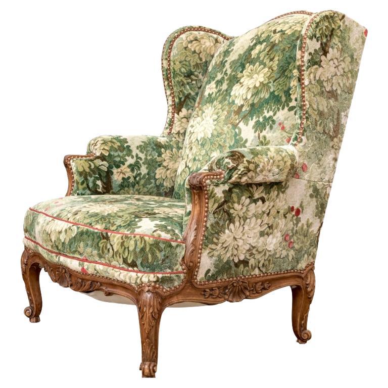 Semi Antique Custom Upholstered Carved Wing Chair For Sale