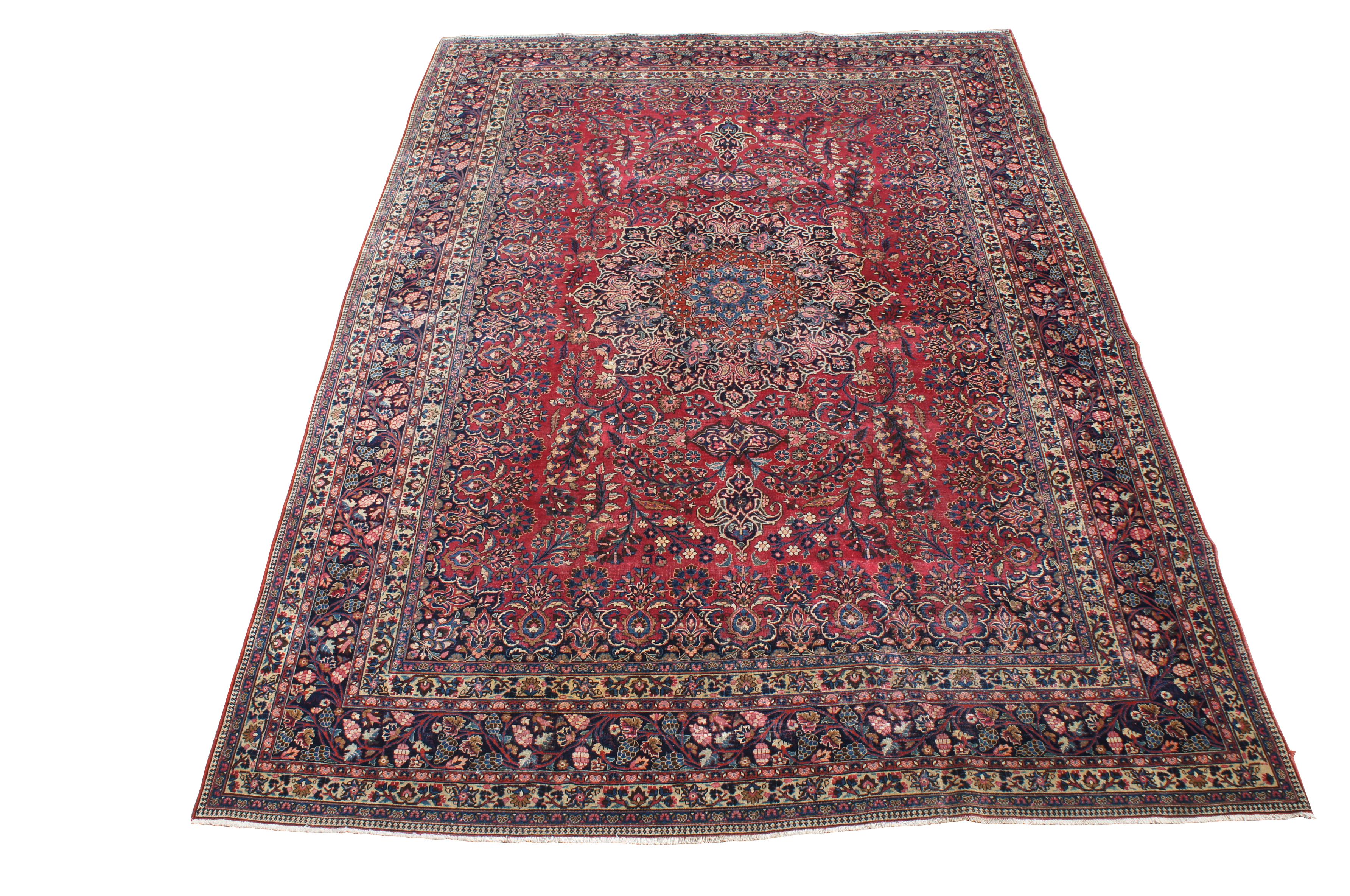 A classic old oriental rug.  Features a tight weave in fine soft wool with deep red and dark blue colors.  The carpet has a brilliant central medallion and is accented my meticulous floral sprays and a layered border with grape vine motif.  144kpsi