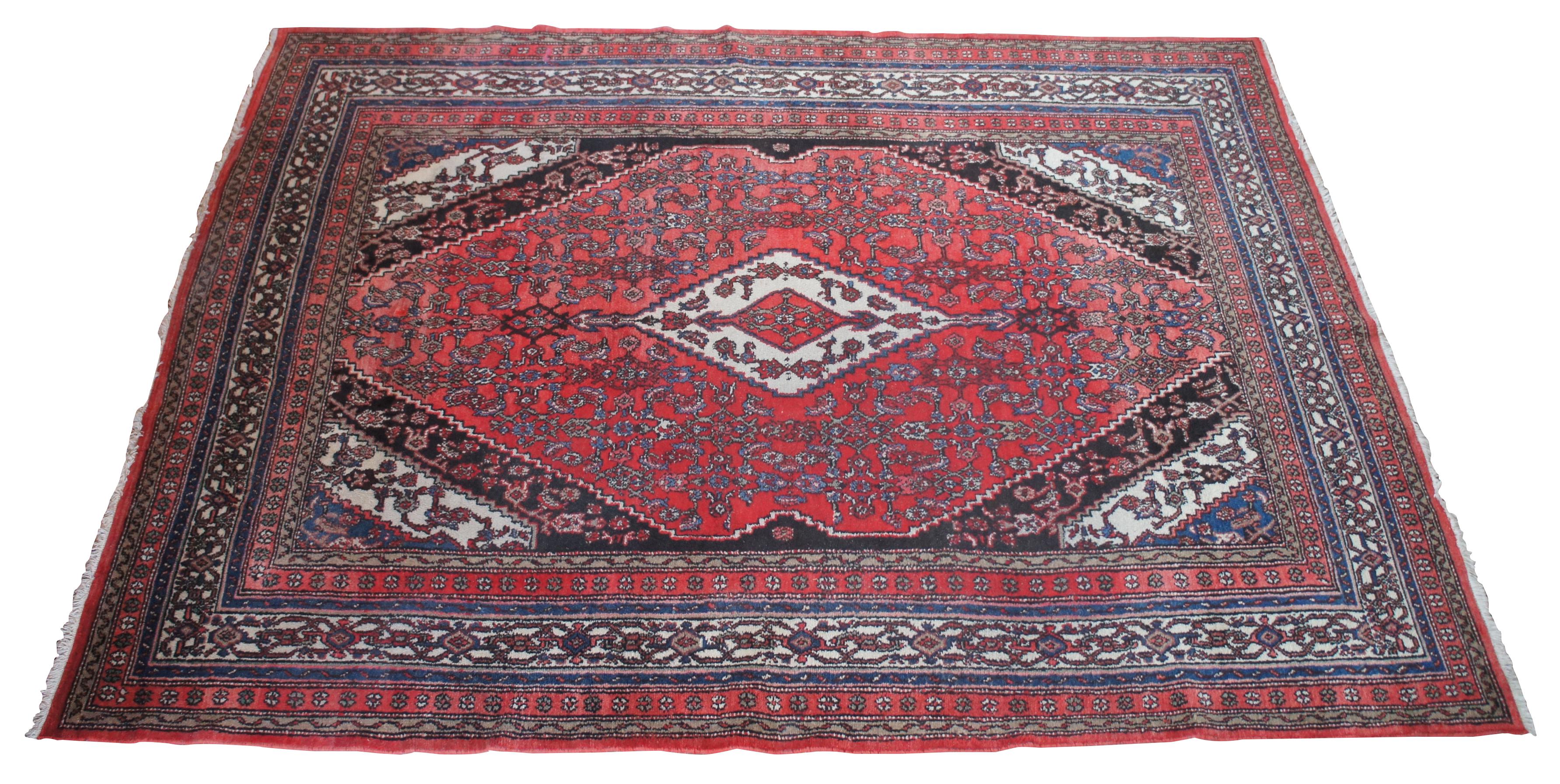 Large antique floral all over area rug featuring a red field with ornate floral accents in greens, blues, pink and brown. Measures: 8.5' x 12'.
 