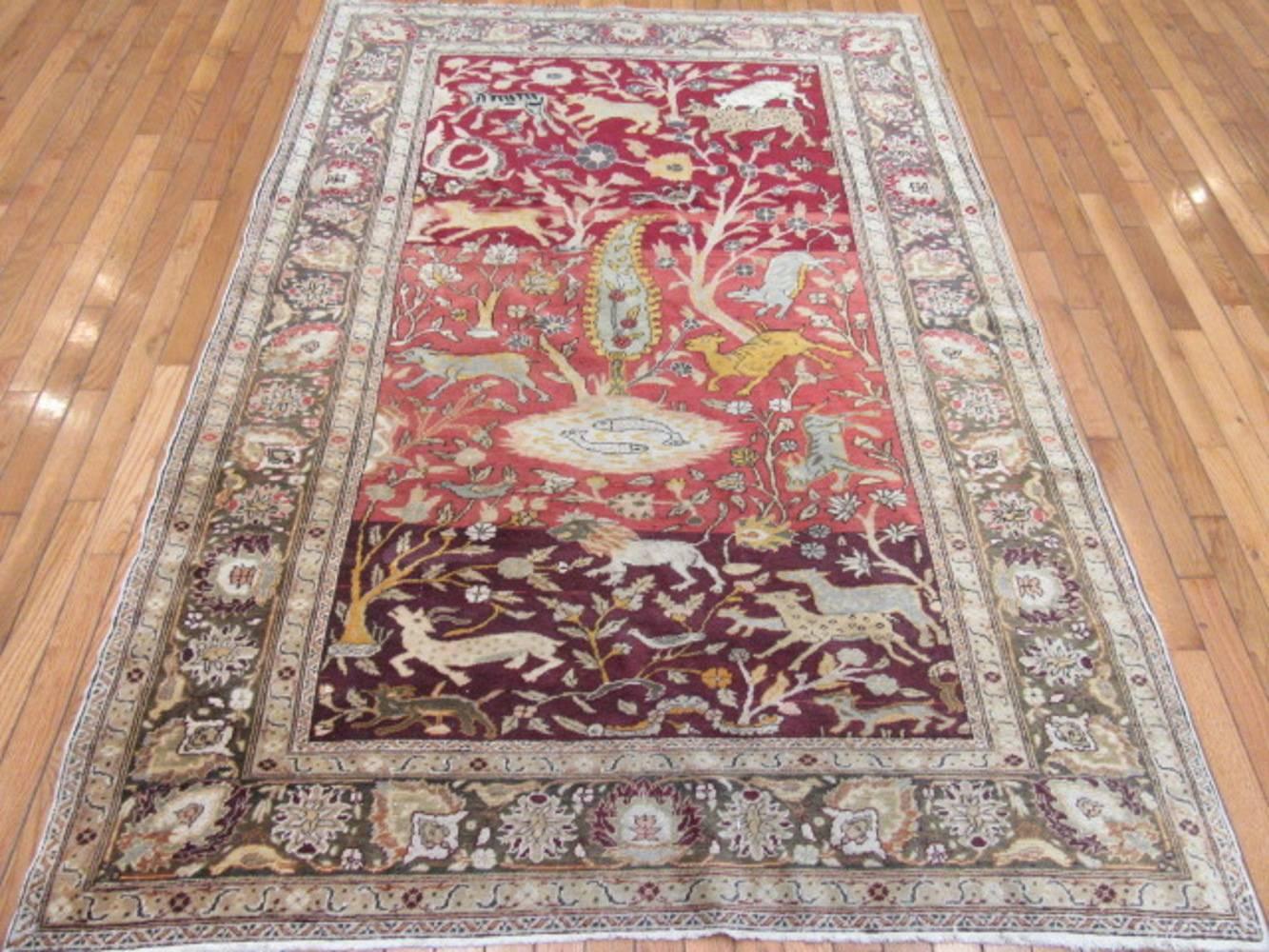 This is a small semi-antique hand-knotted Sivas rug from Turkey with a nature scene design. It is made with wool colored with natural dyes on a cotton foundation. It can be used anywhere even as a tapestry on the wall. The rug measures 4' 9'' x 6'