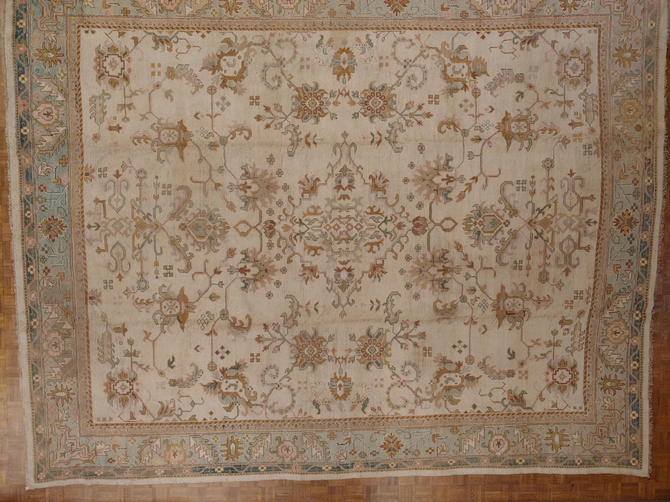 This is an early rug that is a copy of an Oushak design woven in India. With an all-over design and no center medallion, it is very decorative and desirable. Also the soft green border is unusual and splendid. There are several variations of green,