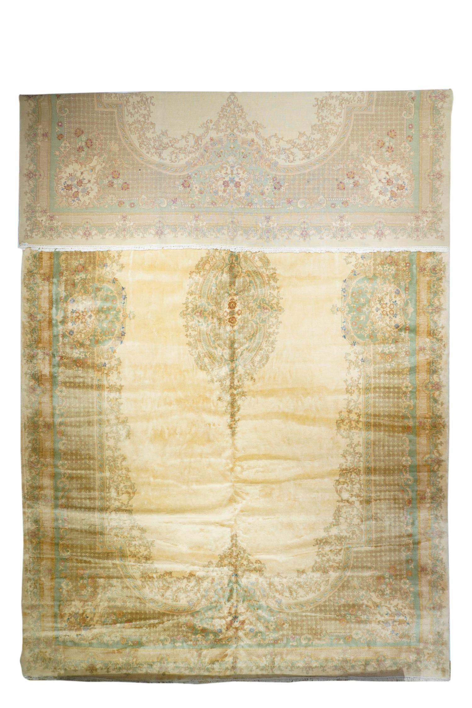 The post WWI French-American style SE Persian city carpet shows an open, cartouche shaped straw-sand sub- field with a filigree surround and en suite slender elliptical medallion. Lattice-work field with Louis-style corner, side and end elements.