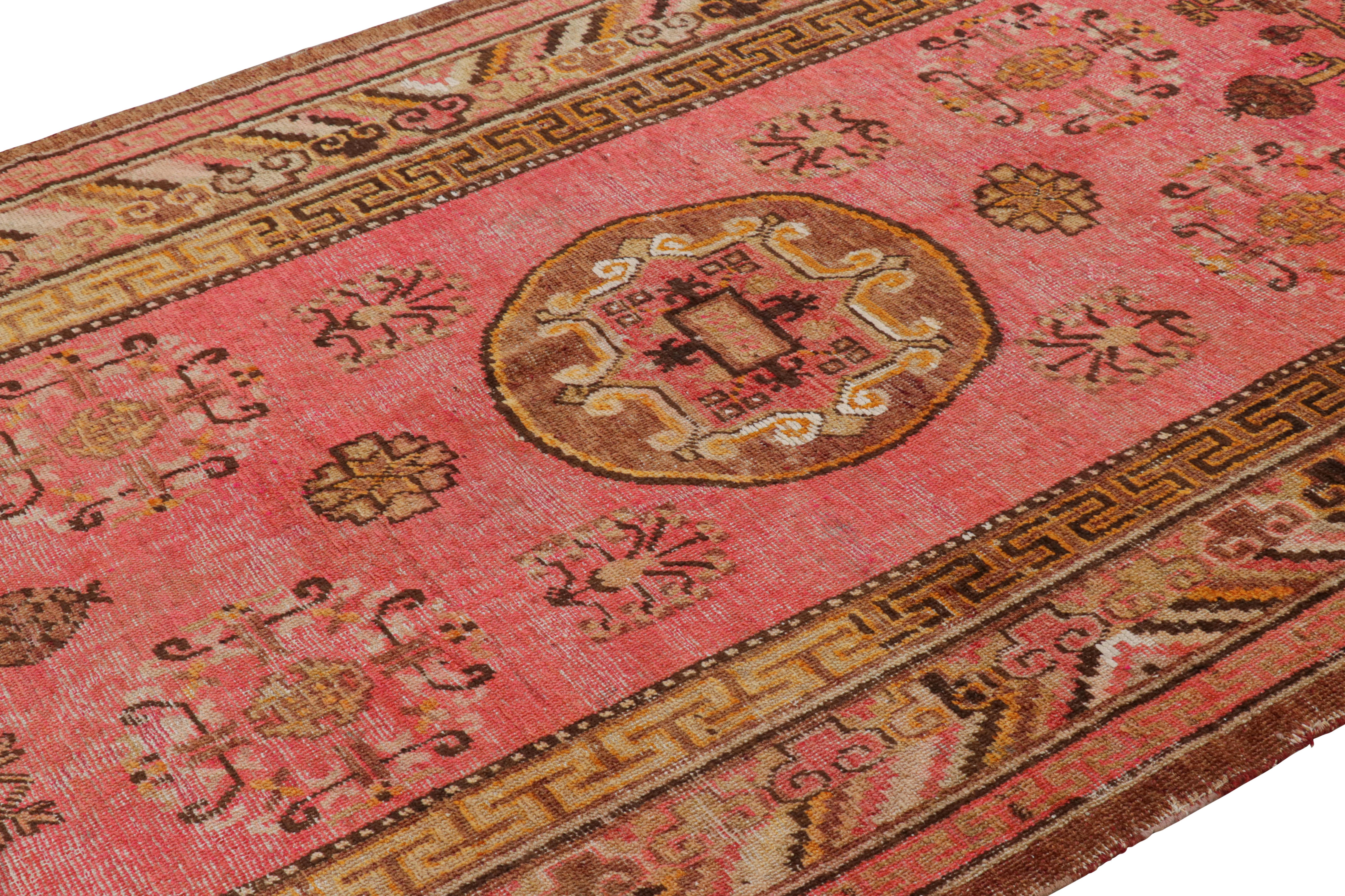 Originating from East Turkestan between 1920-1940, this antique transitional Khotan rug from Rug & Kilim has an abundance of distinct Chinese imagery throughout its borders. Hand woven in high quality wool, the golden-brown medallion design of the