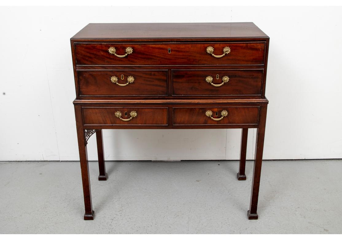 Provenance: Sotheby's NY. The secretary with a drop front in the form of three drawers but opening to drawers and cubby holes. With a black tooled writing surface. The stand with two frieze drawers, fine brass bales overall. Lacking a key. Raised on
