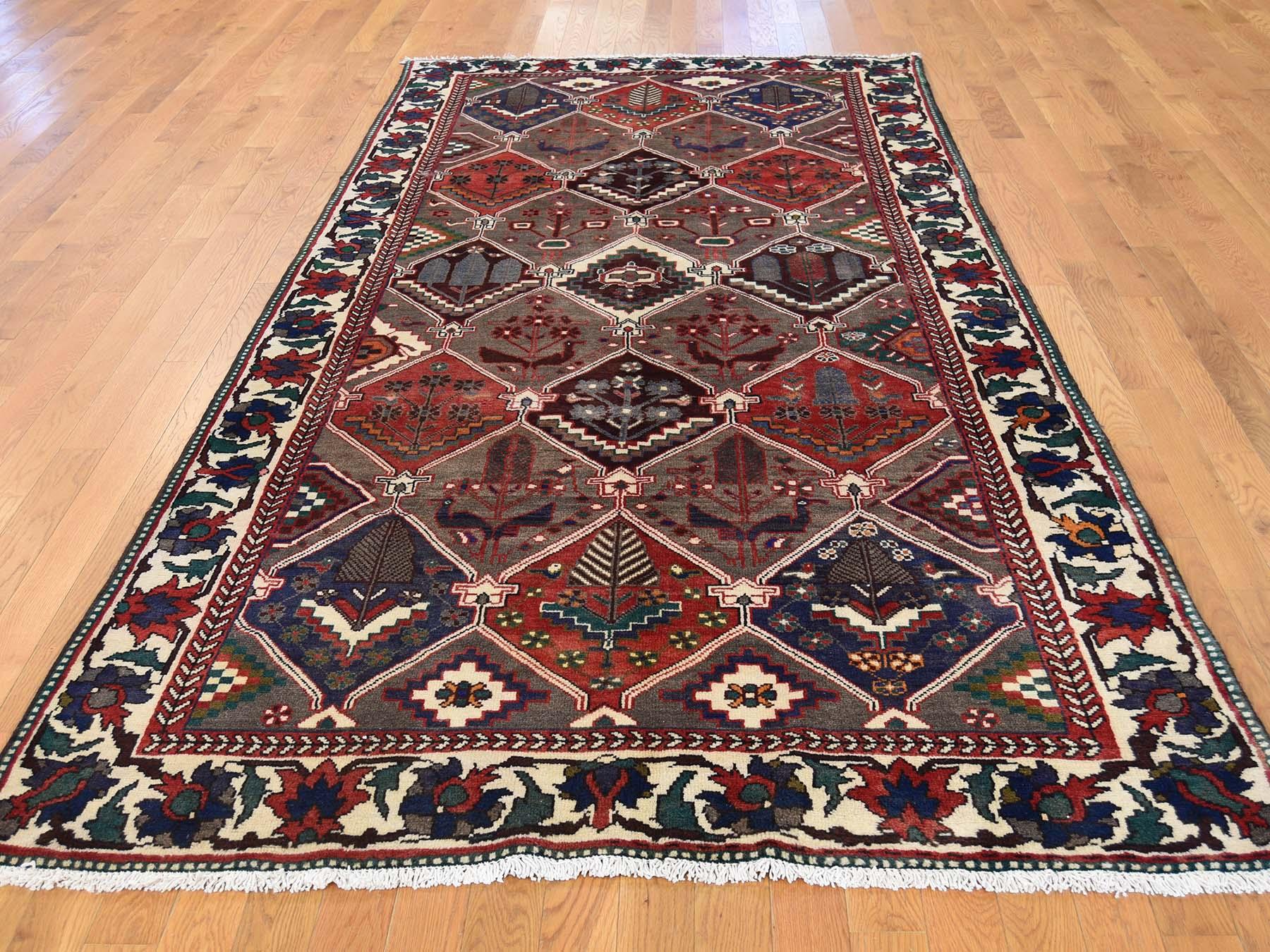 This is a truly genuine one-of-a-kind semi antique Persian Bakhtiari garden design wide runner rug. It has been knotted for months and months in the centuries-old Persian weaving craftsmanship techniques by expert artisans.

Primary materials: