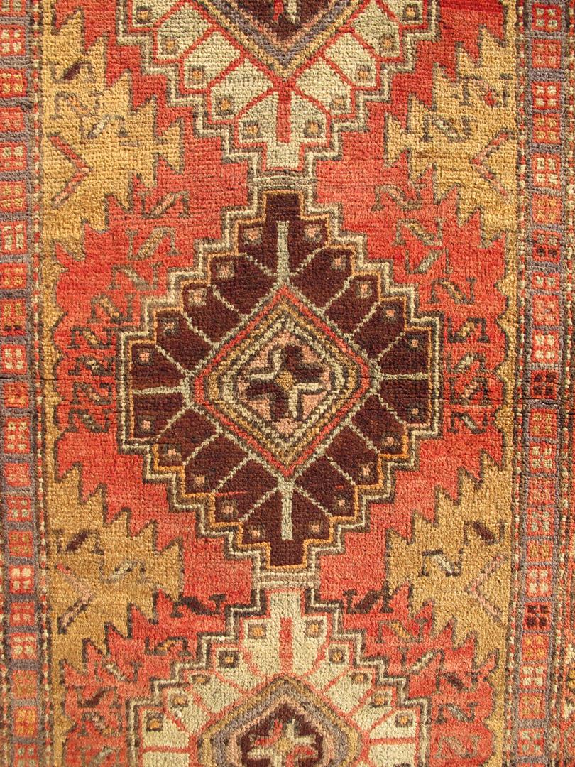 Semi antique Persian Heriz runner rug in soft rusty red, gray and golds rug/H-711-15/. This mid-20th century, handwoven Semi Antique Heriz runner features a red-colored field imbued with a ornate medallions. A beautifully drawn multi-tiered border