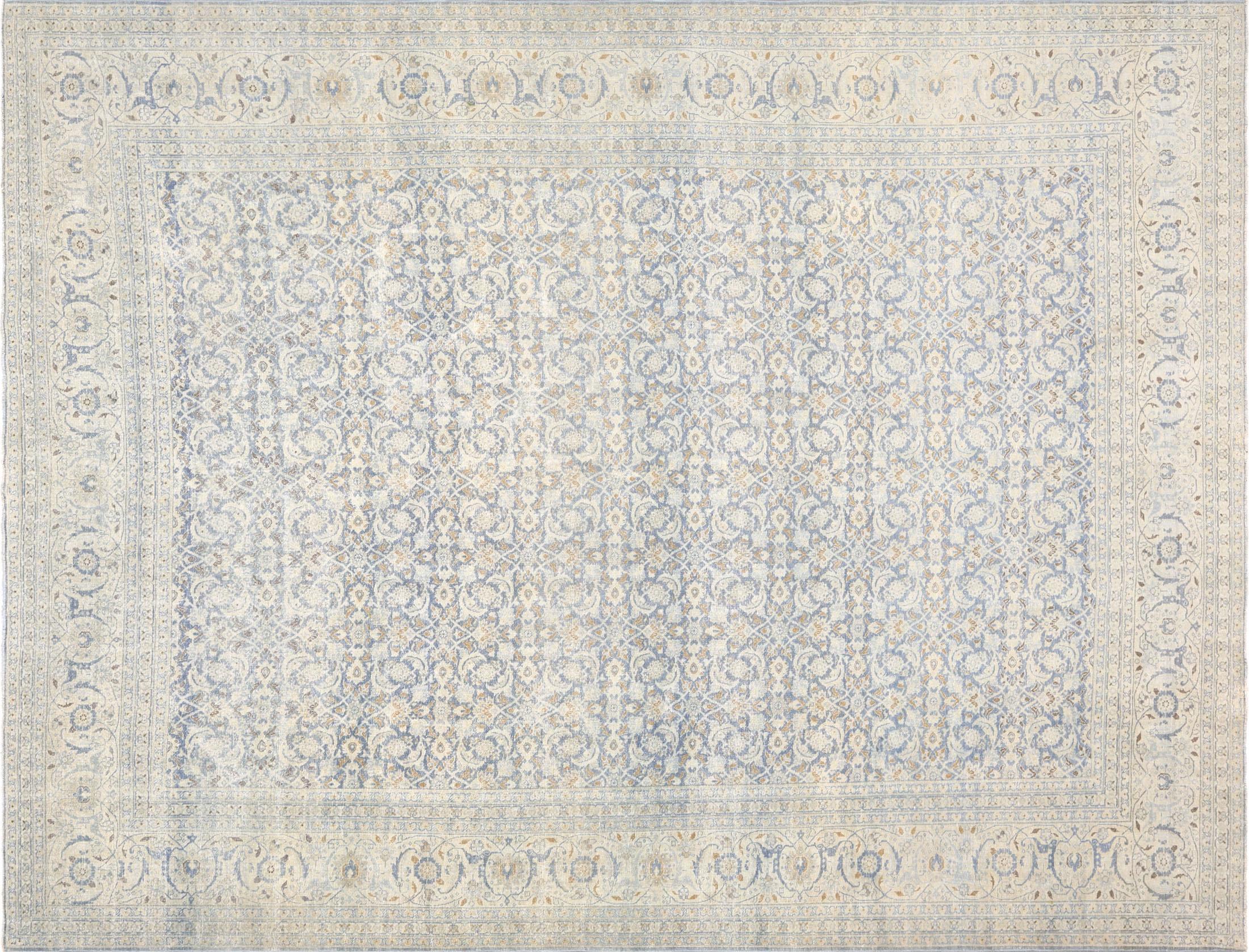 The Semi Antique Persian Tabriz Rug, measuring 9 feet 10 inches by 12 feet 10 inches, is a masterpiece of traditional artistry and design. Its central field features a repeating floral pattern rendered in soft blue and subtle beige tones, exuding a