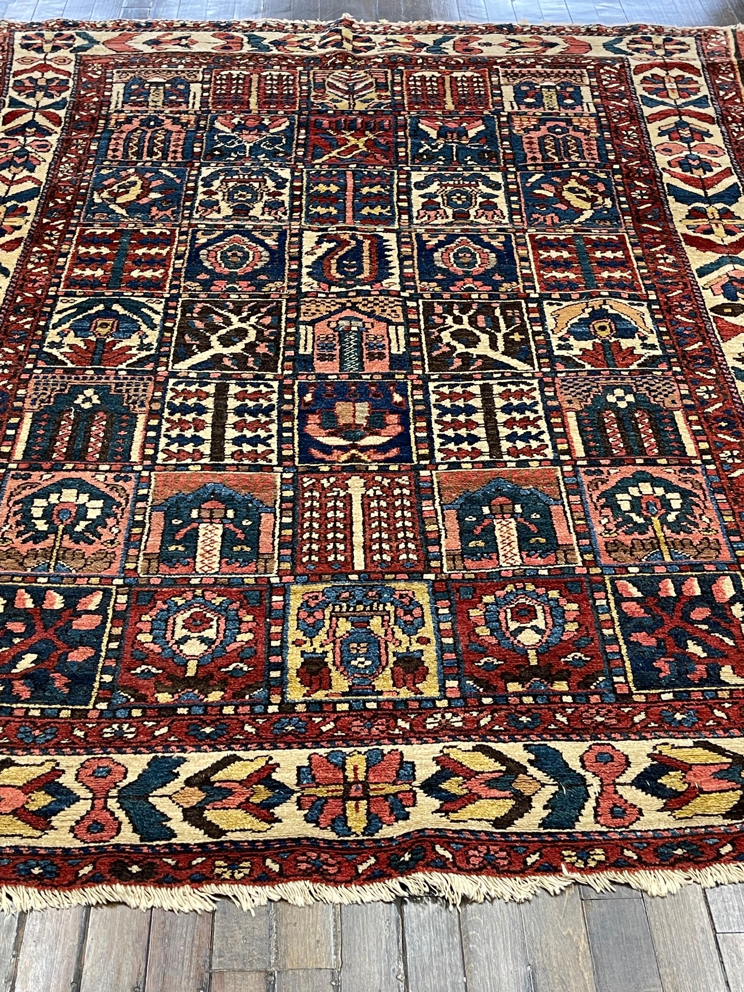 This carpet is handwoven in region Chahar Mahal where the Bakhtiari tribe settled in west central Iran. The field design of compartmentalized tree and flower is the signature pattern of Bakhtiari rugs. The freedom of design overall and the stunning