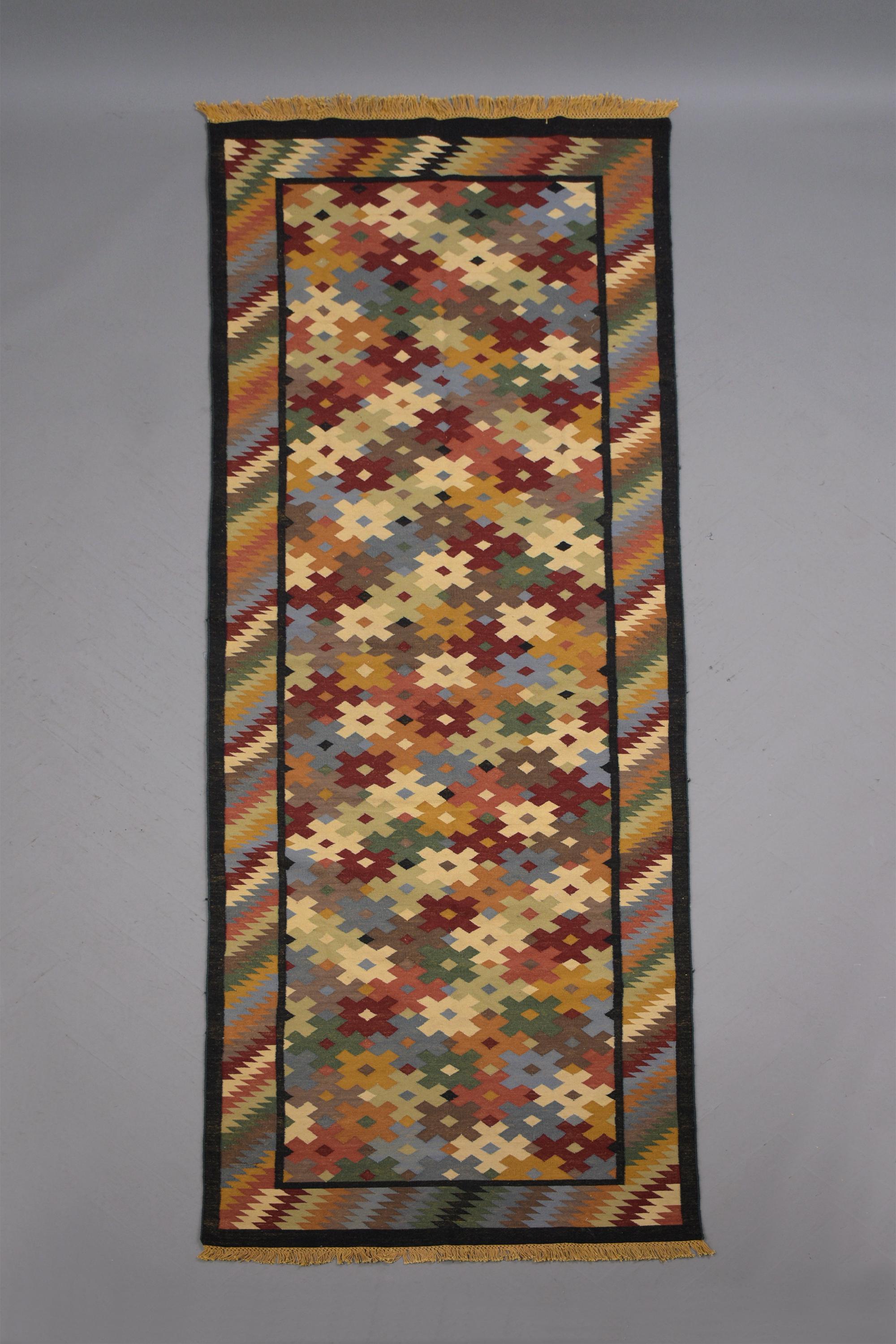 Embrace the allure of the early 1900s with this exquisite textile rug. In great condition, it showcases a vibrant multicolor symmetrical pattern that captures the essence of the era. This unique piece seamlessly blends historical charm with