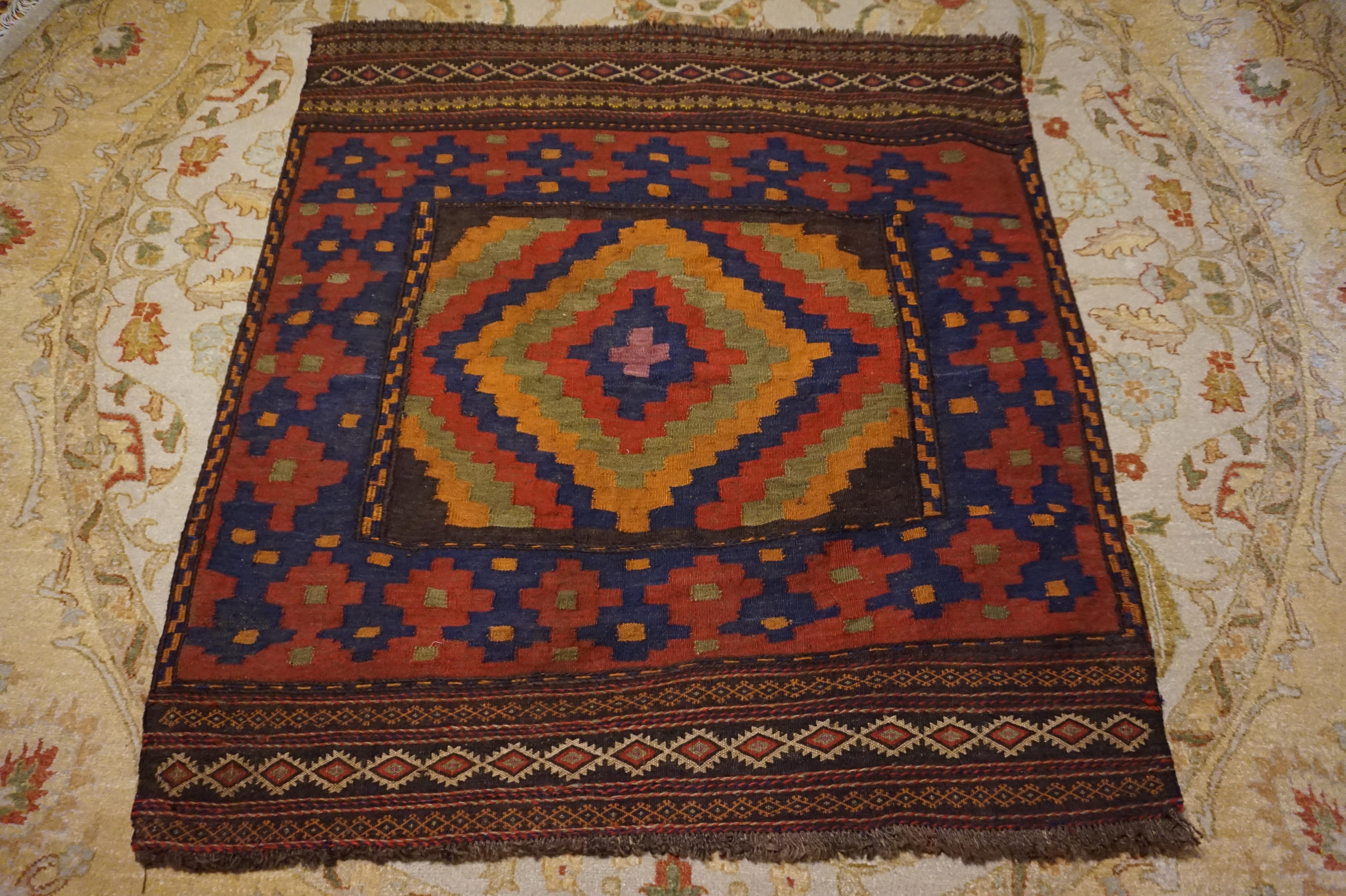 Rare Afghan Kilim with fine border and kite medallion. Excellent hue and impactful pattern. Great warmth and artistry in weave despite compact square size.