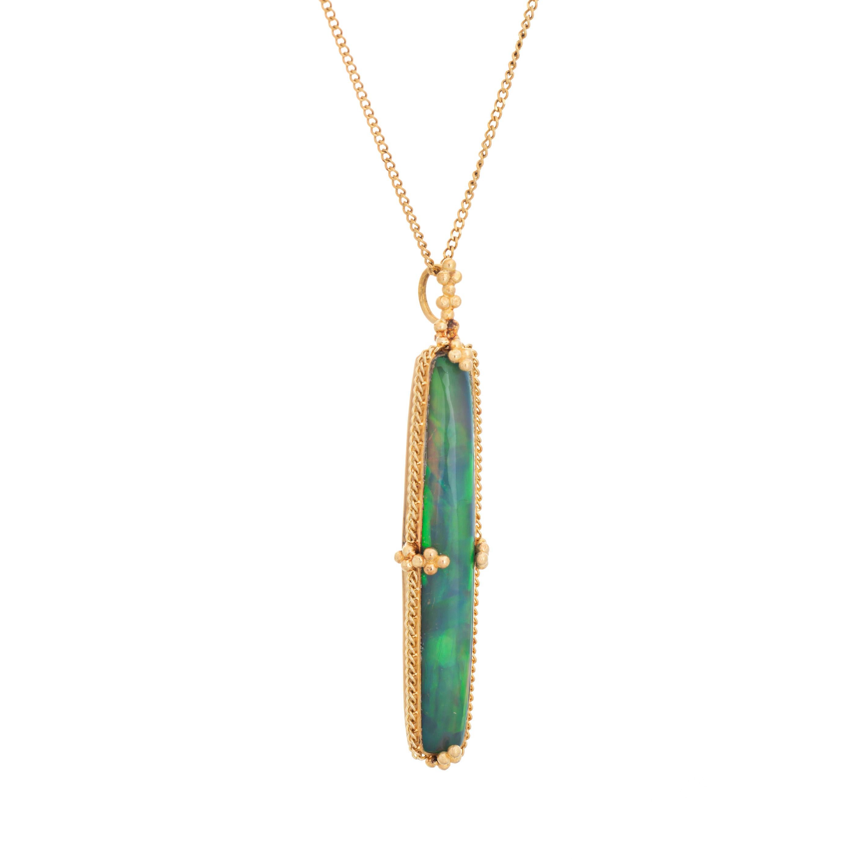 Elegant and finely detailed contemporary estate semi black opal pendant & necklace crafted in 18 karat yellow gold.  

Semi black opal measures 37mm x 6mm. The opal is in very good condition and free of cracks or chips. 

The opal exhibits vivid