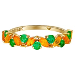 Semi eternity gold ring with opals, emeralds.