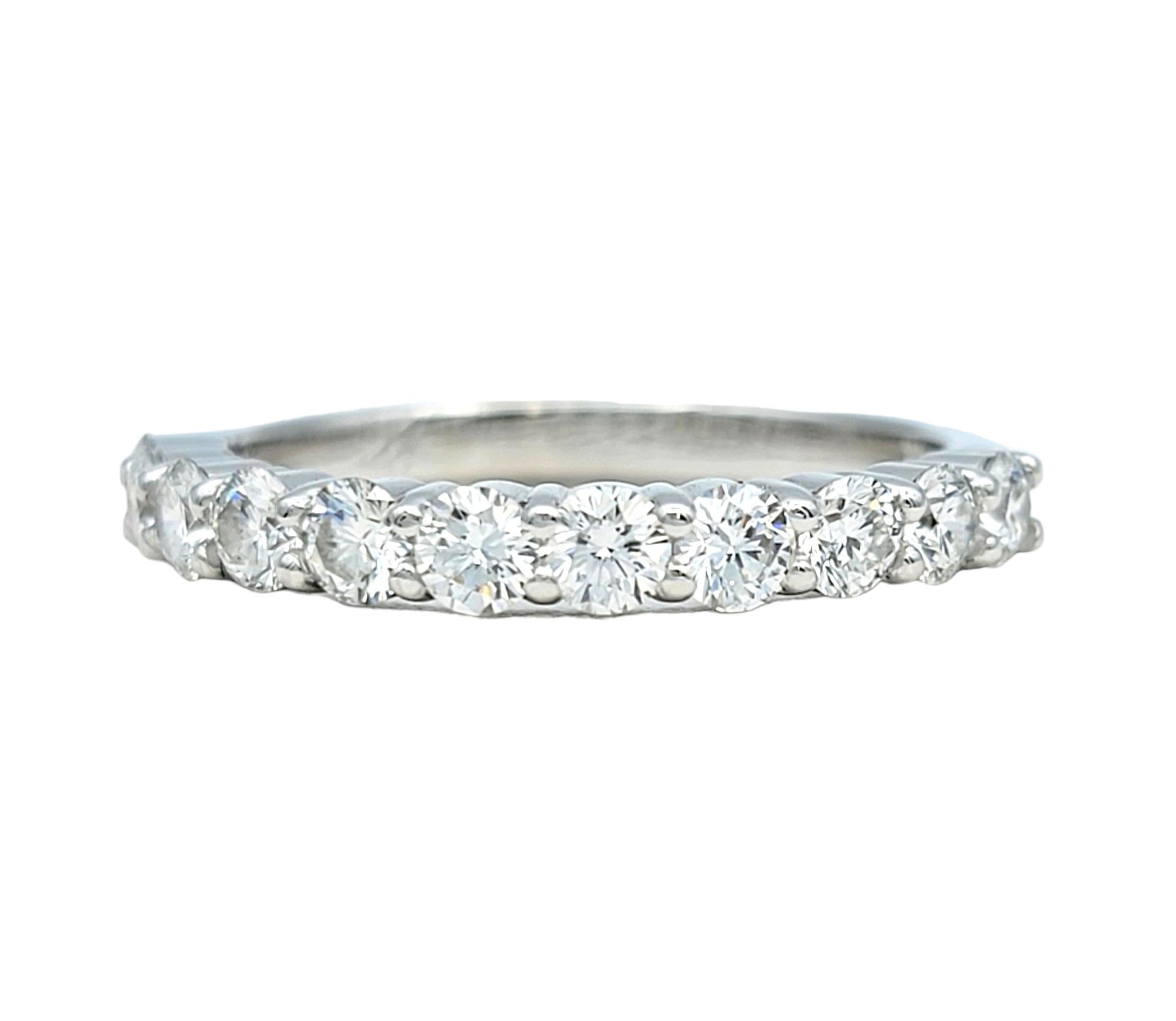 Ring Size: 6.5

This stunning band ring, set in exquisite 18 karat white gold, features a classic and versatile design. The semi-eternity style showcases a continuous row of round diamonds, creating a timeless and elegant appearance. This design is