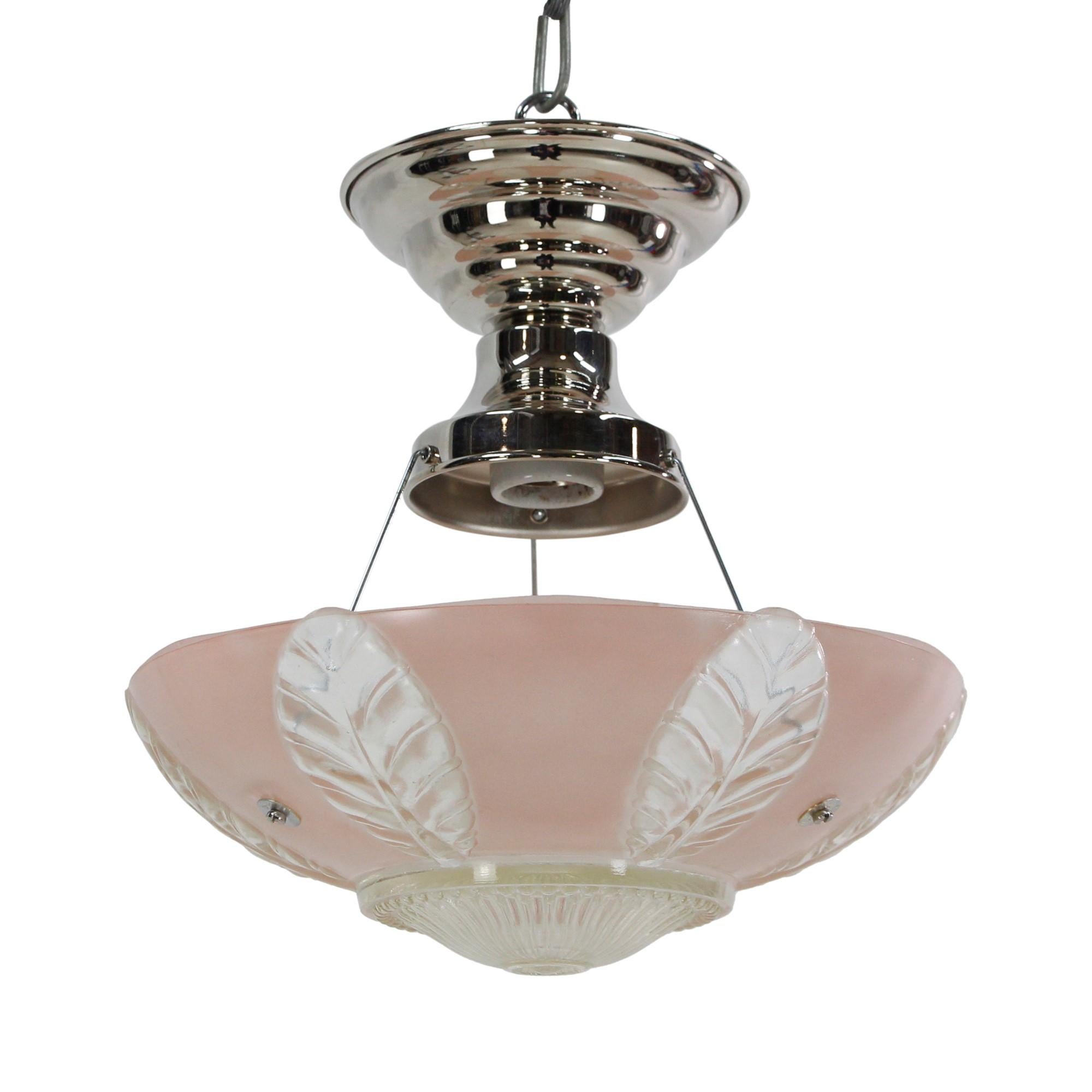 1940's semi-flush mount dish light featuring a pink and clear glass shade with foliage details and clear glass ribbed details on bottom. Comes with new polished nickel hardware. This can be seen at our 400 Gilligan St location in Scranton, PA.