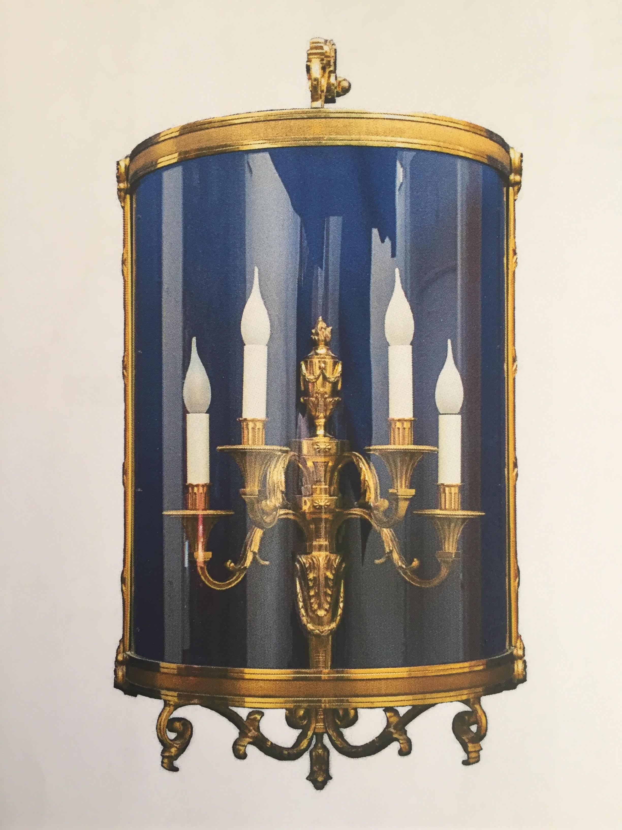This old gold finish wall sconce represents a half lantern with four lights. The carvings and fine details make it an exceptional Classic piece.