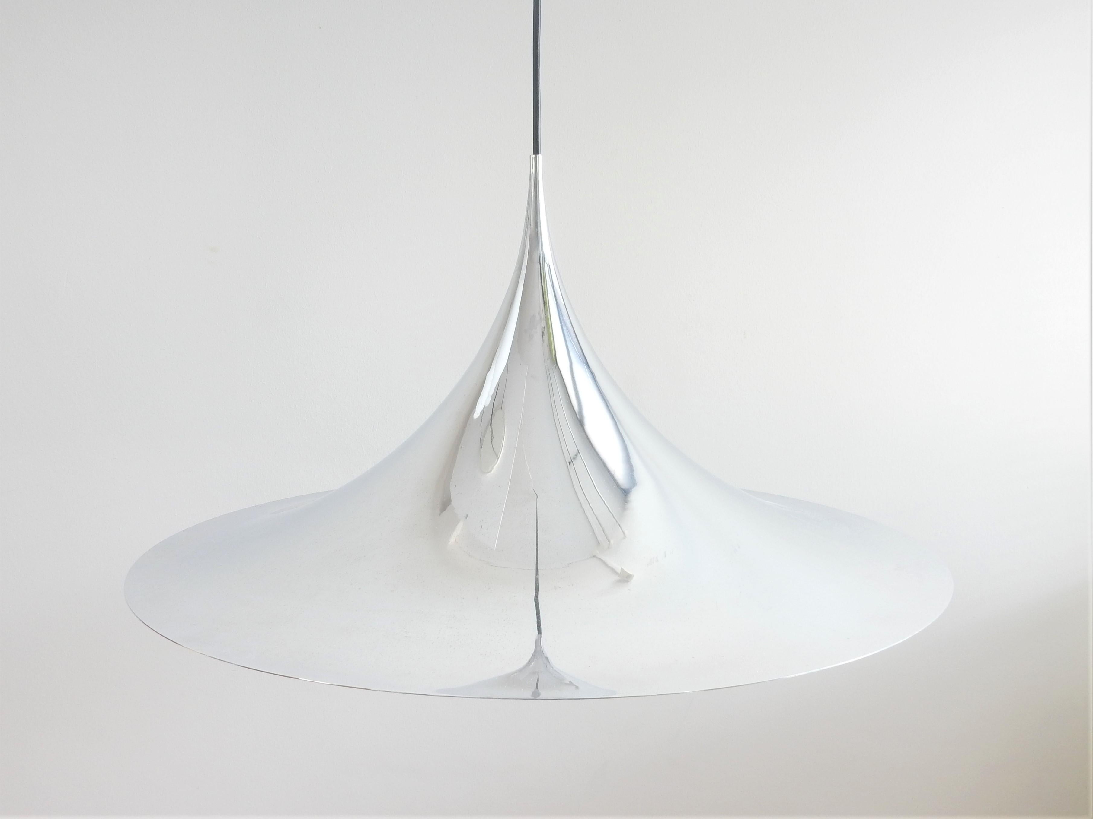 This famous model 'Semi' or 'witch hat' pendant lamp was designed by Claus Bonderup and Torsten Thorup for Fog & Mørup in 1968. This piece is in chrome-plated metal and is the largest and most charming version with a diameter of 70 cm. A beautiful