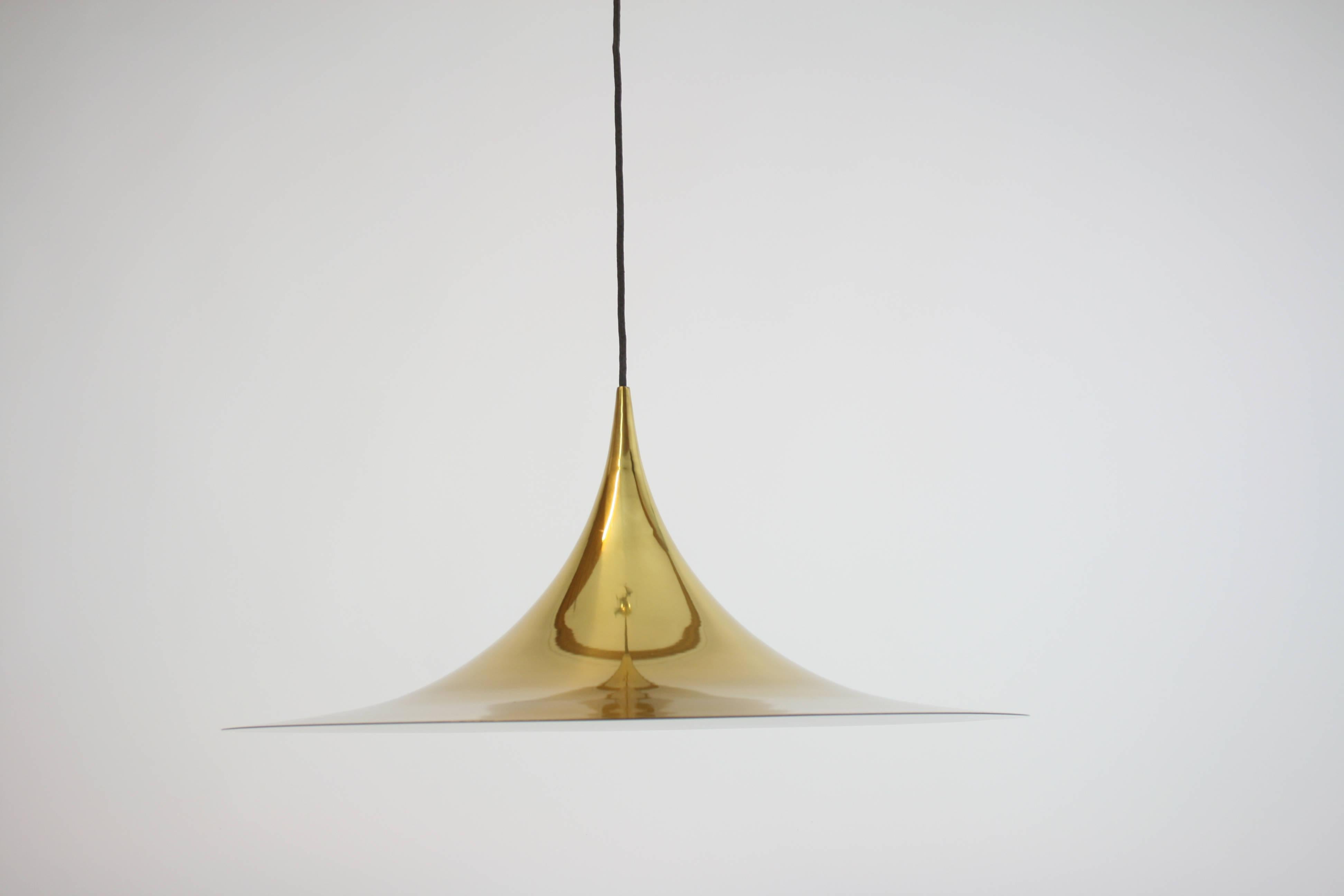 Large pendant designed by Claus Bonderup and Torsten Torup for Fog&Morup, Denmark, 1967. The quality and timeless extravagance of this iconic design remains valid up to our days. Its polished brass surface increases the degree of elegance many times