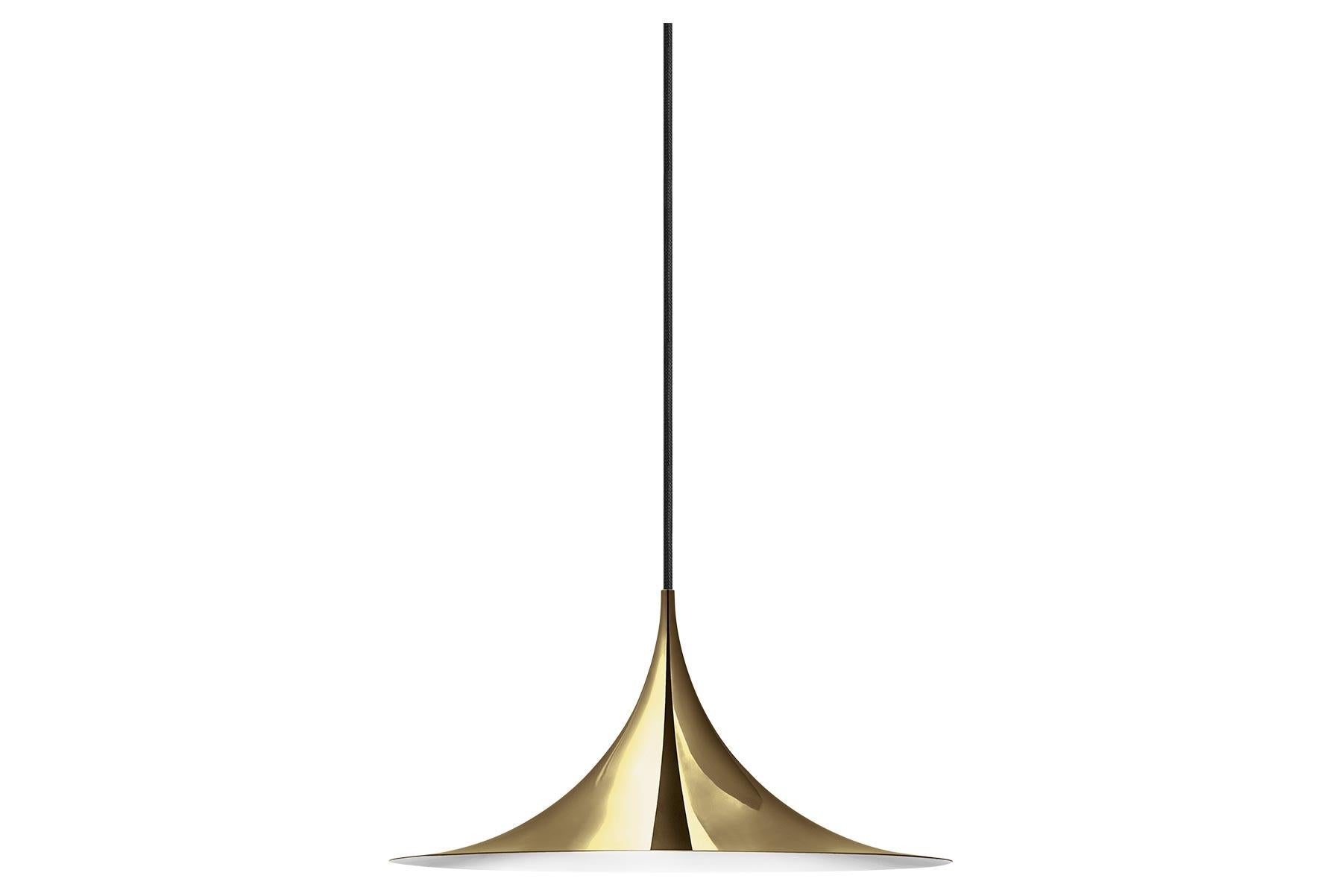 The semi pendant is a unique pendant lamp, based on two quarter-circles put together, back-to-back. Its distinctive arch-shaped, enameled metal shade creates a diffused, cone-shaped light, ideal over a dining table or kitchen work surface. With its