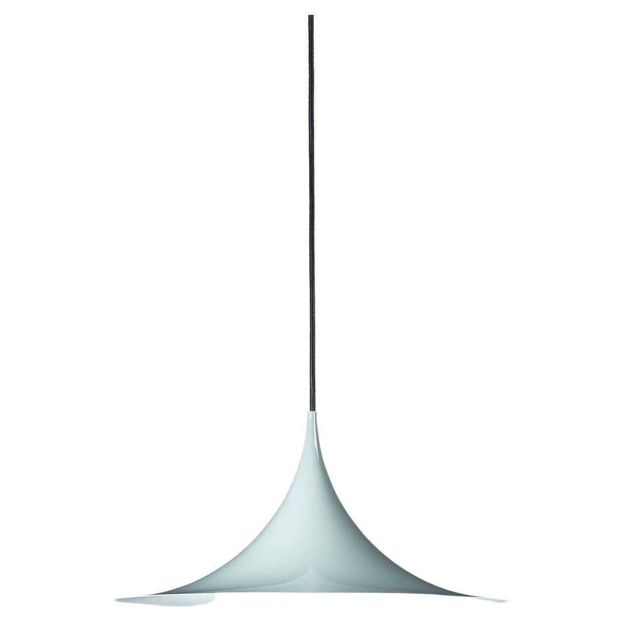 The Semi pendant is a unique pendant lamp, based on two quarter-circles put together, back-to-back. It’s distinctive arch-shaped, enamelled metal shade creates a diffused, cone-shaped light, ideal over a dining table or kitchen work surface. With