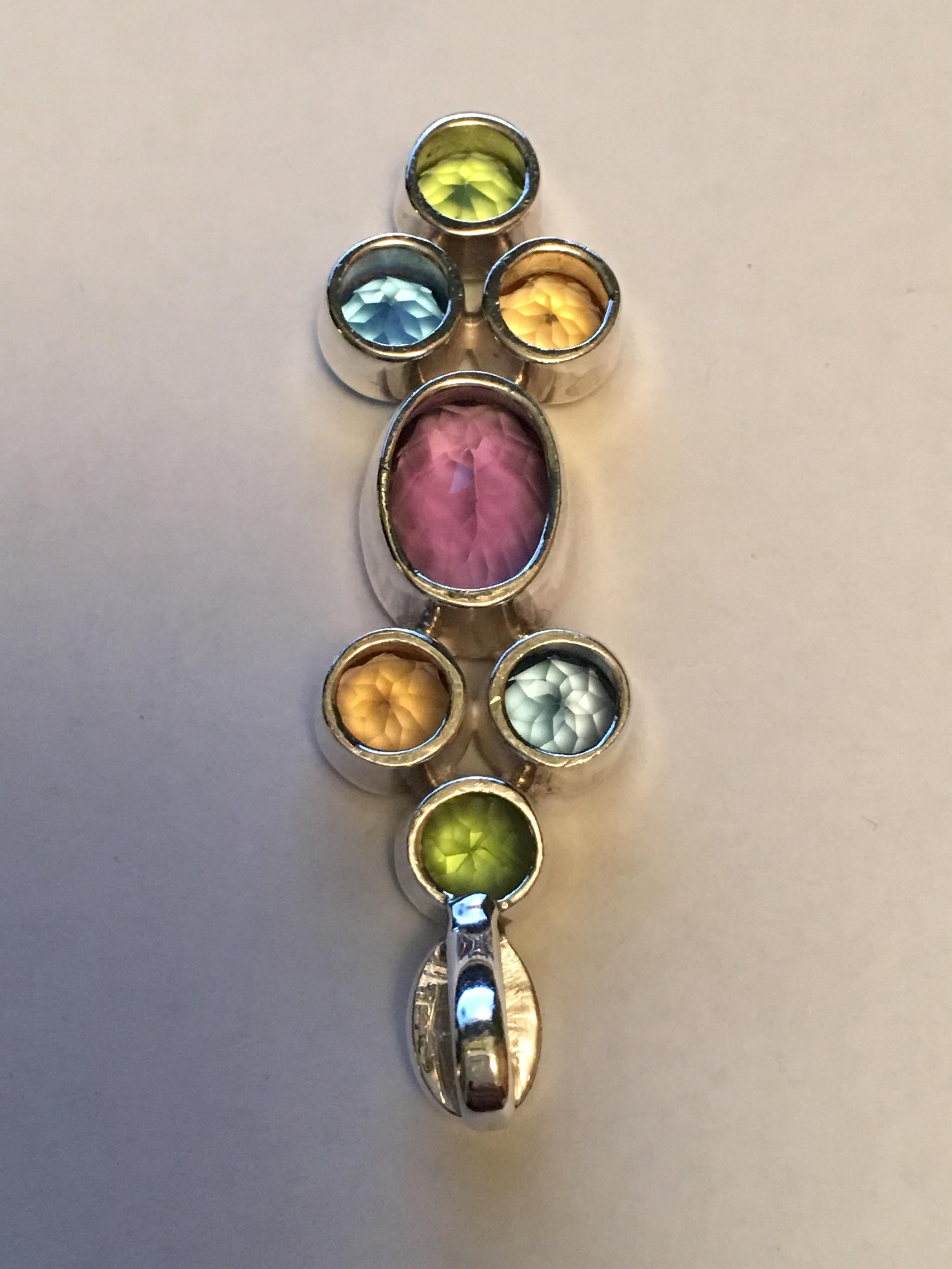 Oval Amethyst 10 MM X 14 MM Round Peridot, Citrine and Blue topaz all measure 7MM.
All stones are hand cut and Polished stones.
The Pendant is one of a kind and hand crafted.
Pendant weigh 11.07 gram.
One can wear this pendant with silver chain or