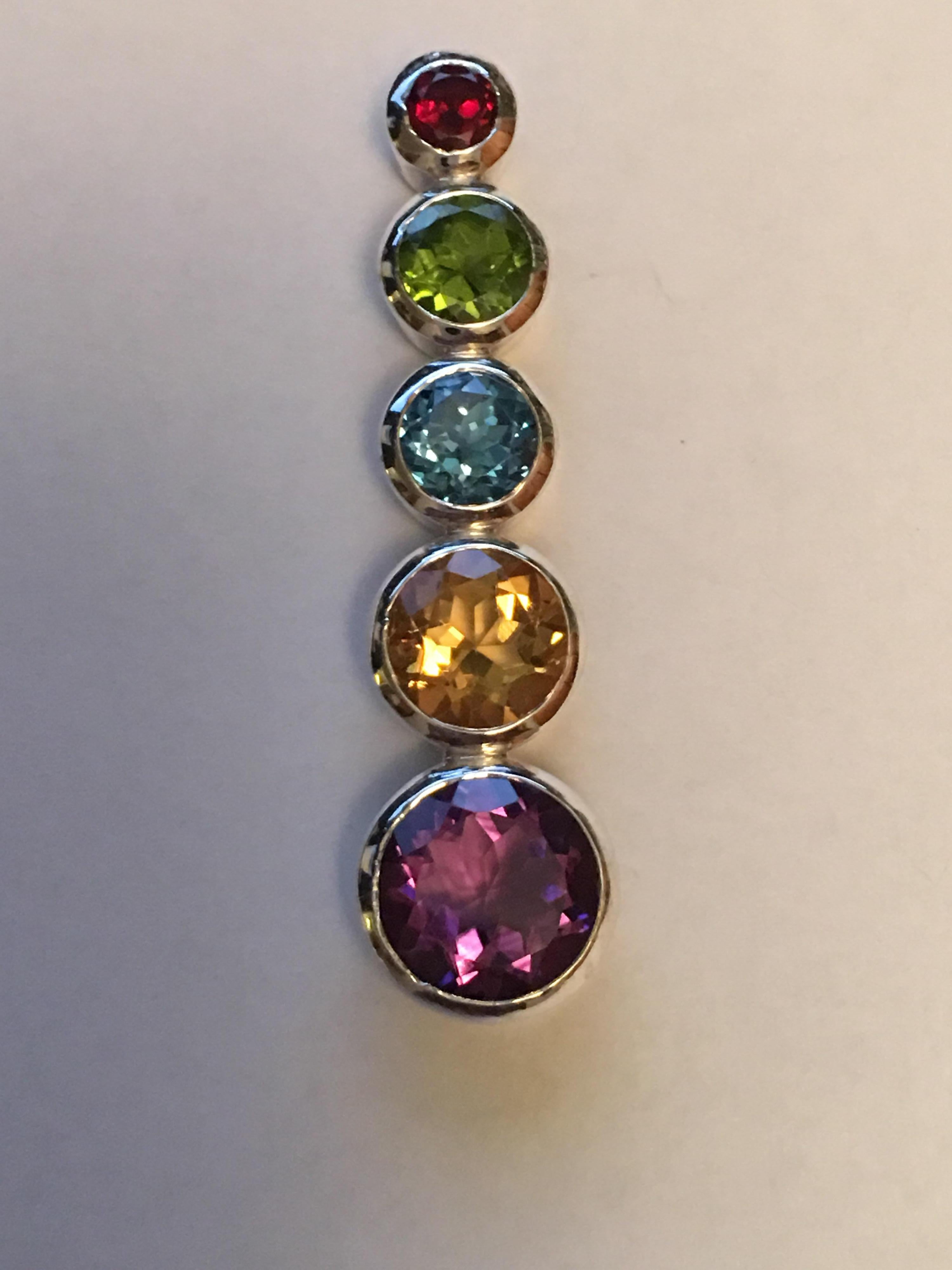 Natural stones Red Garnet 4 MM, Peridot 7 MM, Blue Topaz 7 MM, Citrine 9 MM and 11 MM Amethyst set in sterling silver. 
Hand crafted one of a kind pendant.
All stone are hand cut and polished.
Chakra Pendant can be worn on leather band or sterling