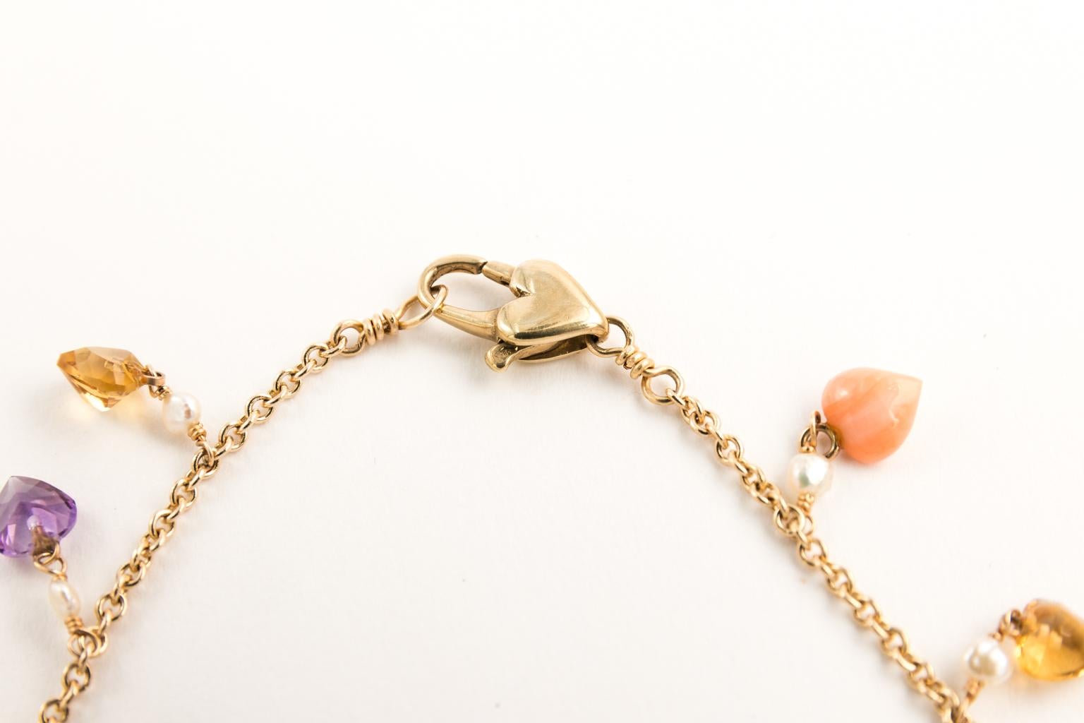 14 Karat Yellow Gold Keshi Pearl and 37 semi-precious heart shaped stone necklace in multi colors.
