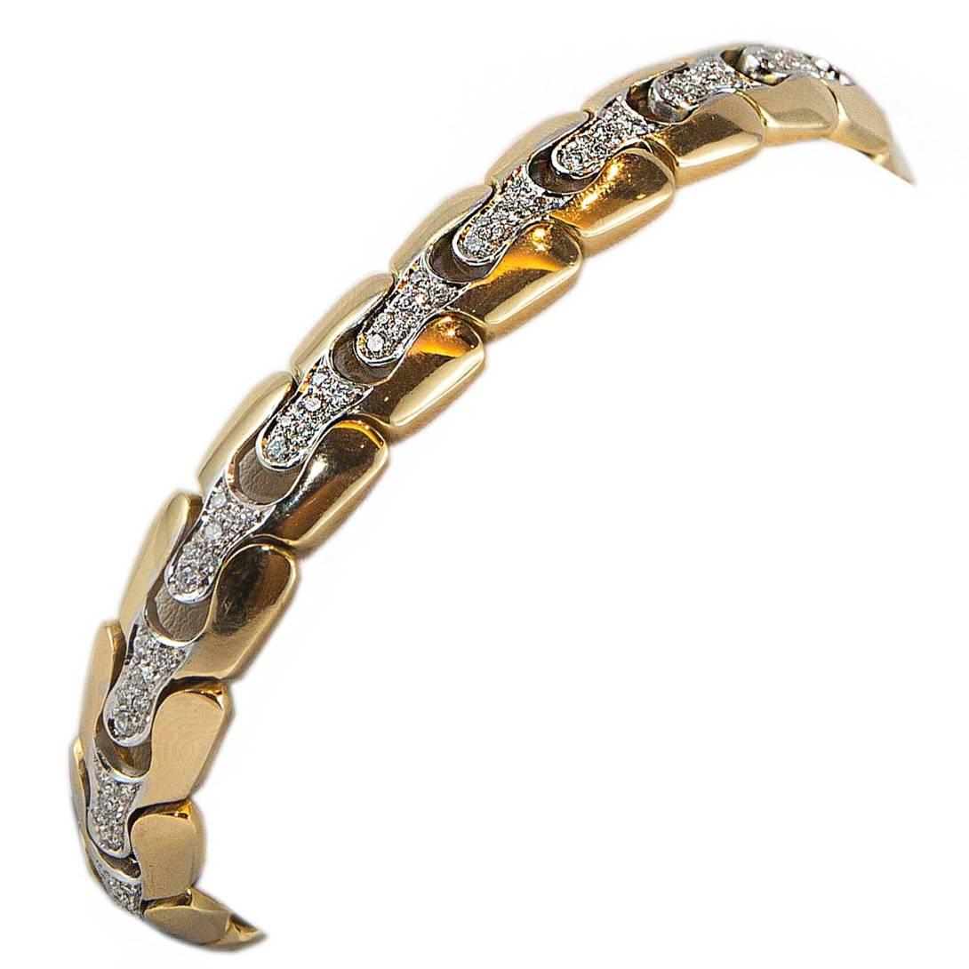 A semi-rigid bracelet crafted in 18k yellow and white gold with 1,42 carats brilliant cut diamonds. 