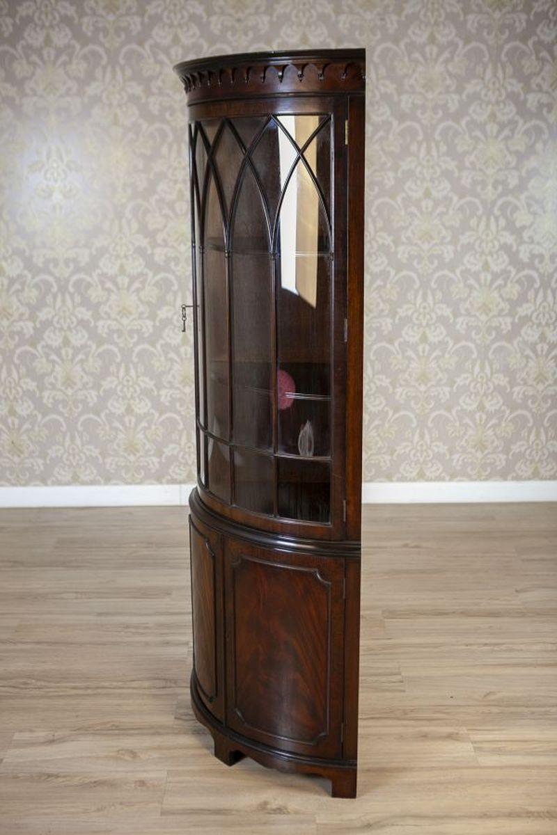 Semi-Round English Corner Display Cabinet From the Late 19th Century

An English corner display cabinet, dated to the late 19th century. The lower section is solid, enclosed by key-operated doors, while the upper section houses three shelves inside,