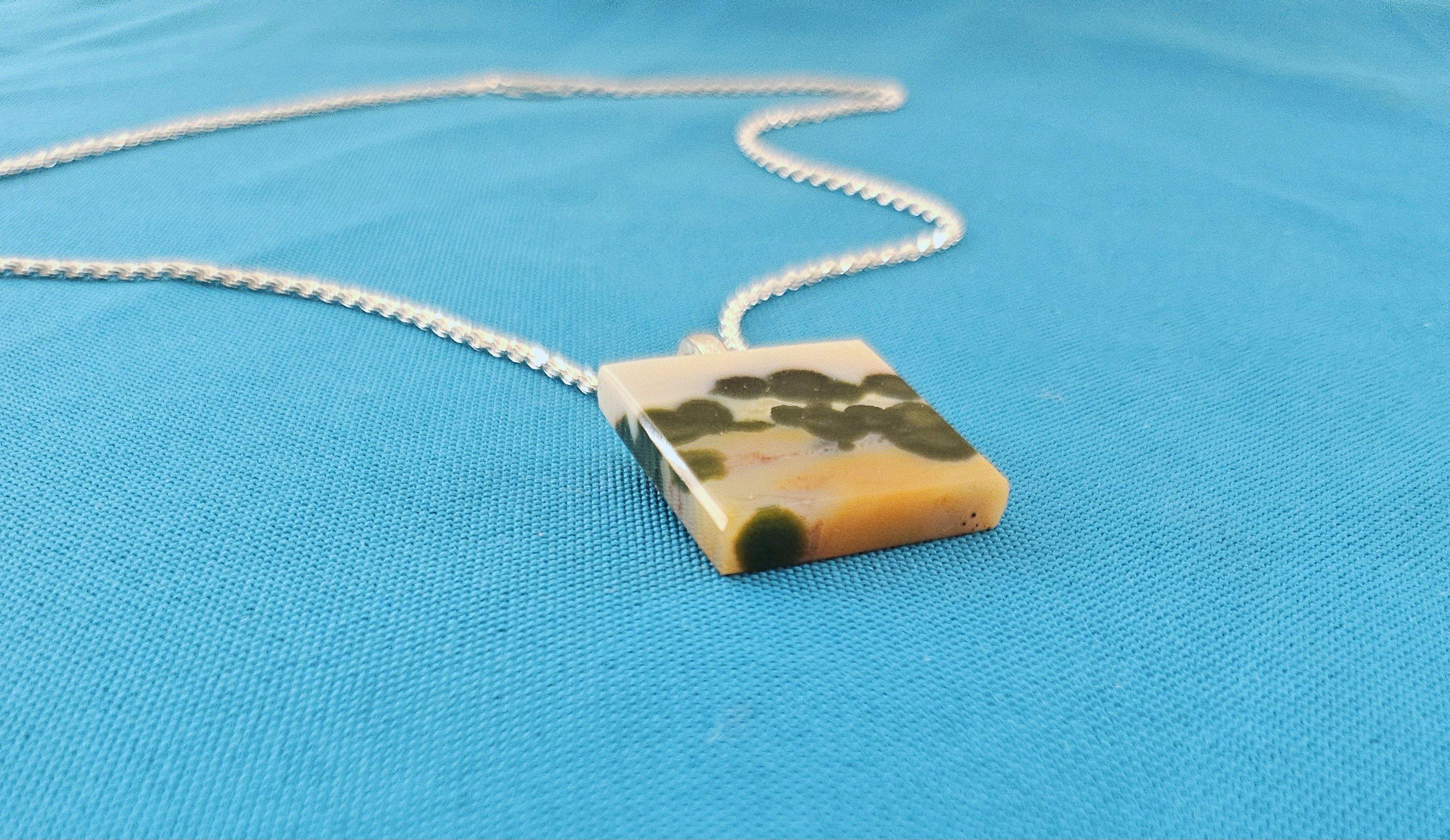 Semiprecious Stone Pendant on Sterling Silver Chain-Naturally Occuring Landscape Appears in the Polished Stone. 
This is a beautiful pendant necklace, unique unto itself with its naturally occurring landscape in the stone. 
The chain connector is
