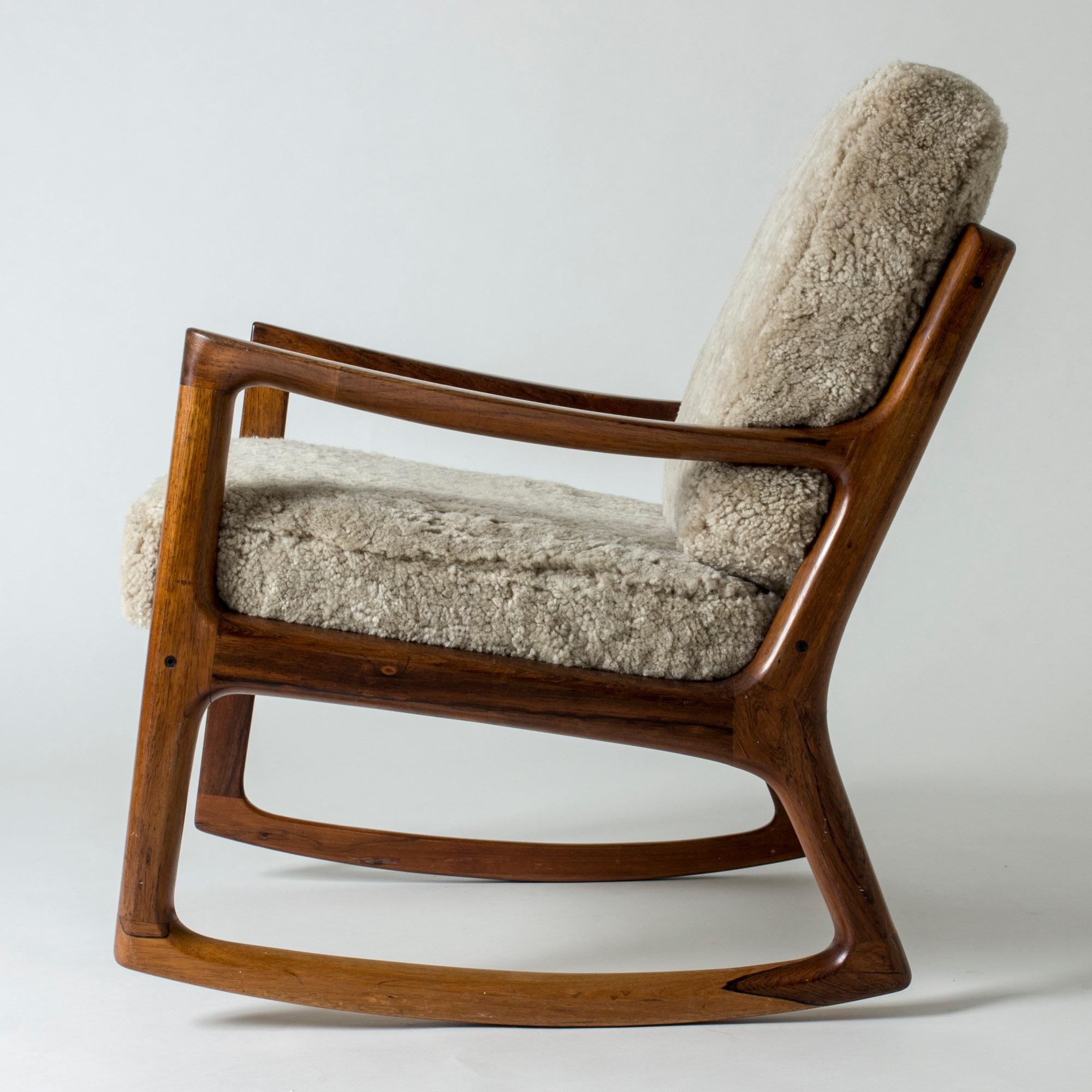 Amazing “Senator” rosewood rocking chair by Ole Wanscher. Beautiful, streamlined frame with an open silhouette, cushions upholstered with sheepskin.