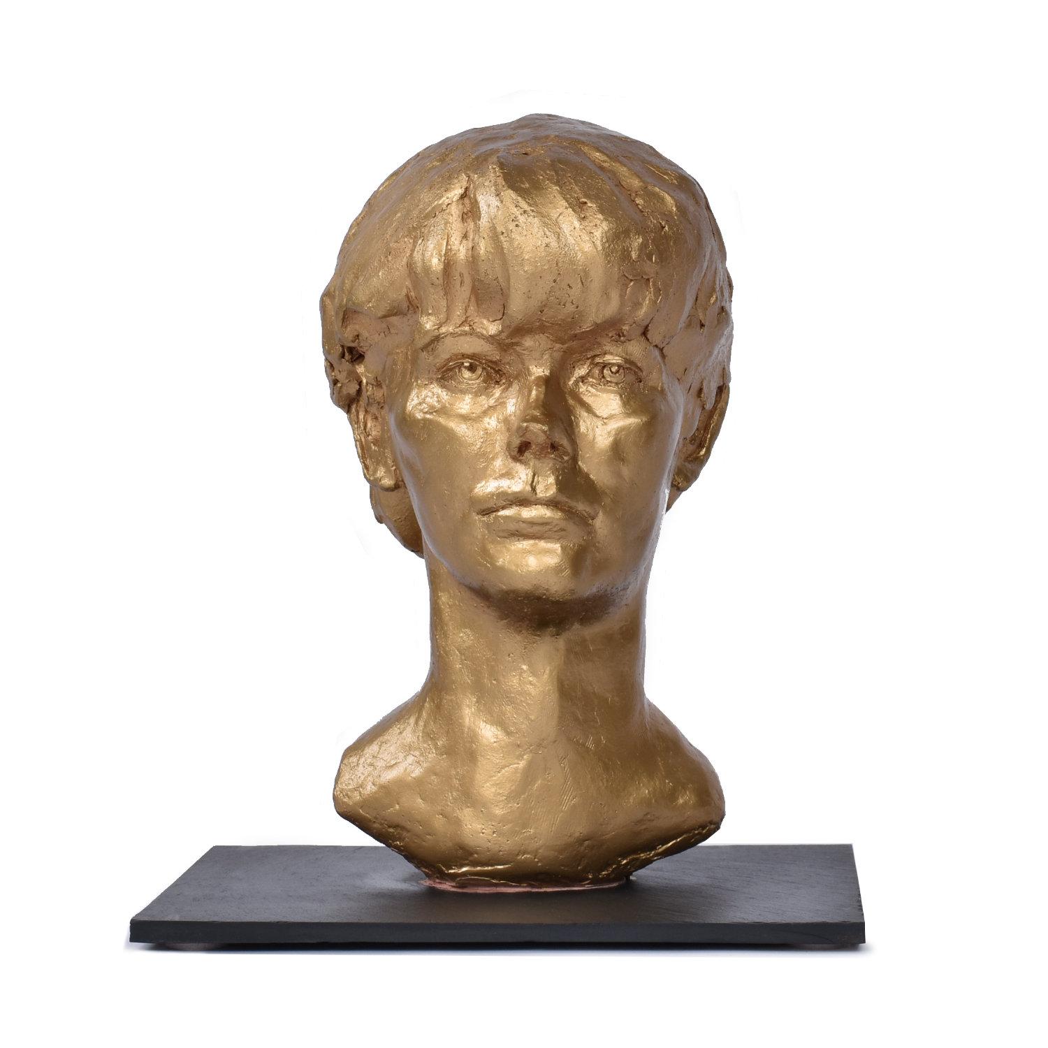 This listing is for the bust alone. The marble pedestal is sold separately.

Hand crafted bust of a young boy, signed “Sendelbach.” The sculpture is crafted from clay and finished in gold paint. The piece is mounted to a slate pedestal. Artist