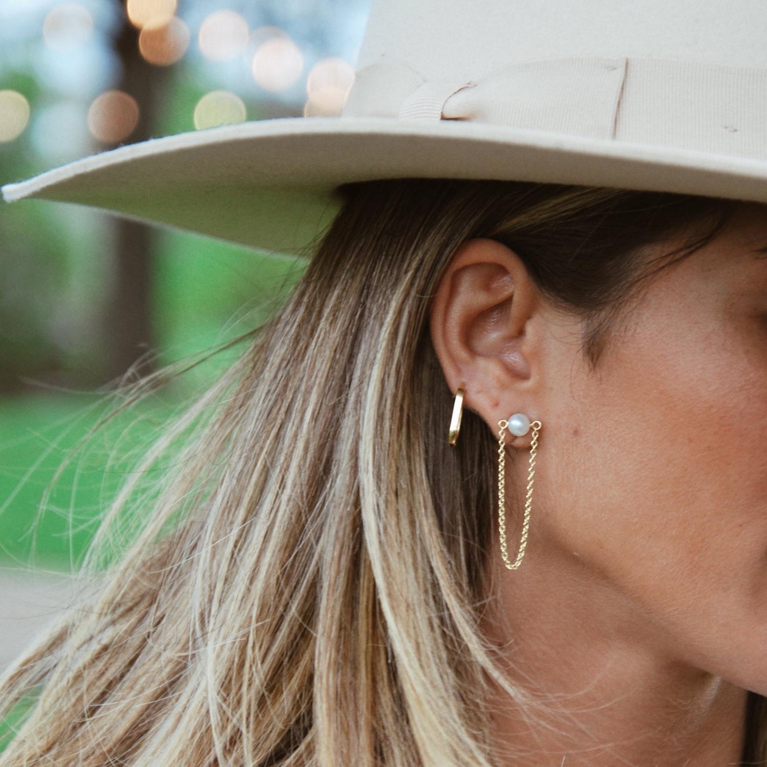 Our Veil Earrings include a chain drape moment for a fresh and modern take on the classic pearl stud design. 

These earrings can also be incorporated into our Infinity Earrings to spice up your every day look. We love a subtly mismatched pair, so