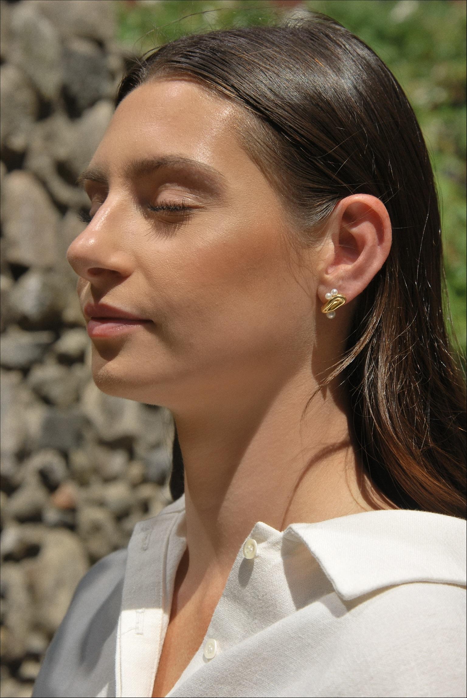 Understated elegance is finally here with a fresh take on classic pearls for the summer. The Paloma Studs are handcrafted with freshwater pearls and organic gold shapes. Take this set from the sun-kissed days to salty summer nights. Made with Plated