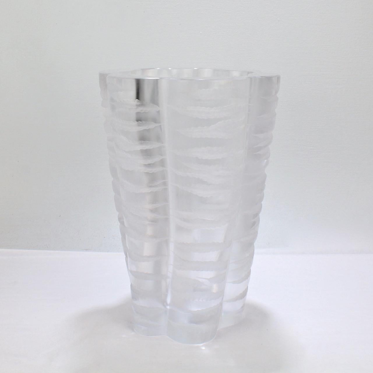 A very fine verison of the Senlis vase by Marc Lalique for Lalique.

This is one of the great designs by René Lalique's heir, Marc Lalique. The tapered, beaker-form vase is thick walled and quite substantial. It has a scalloped border and a body