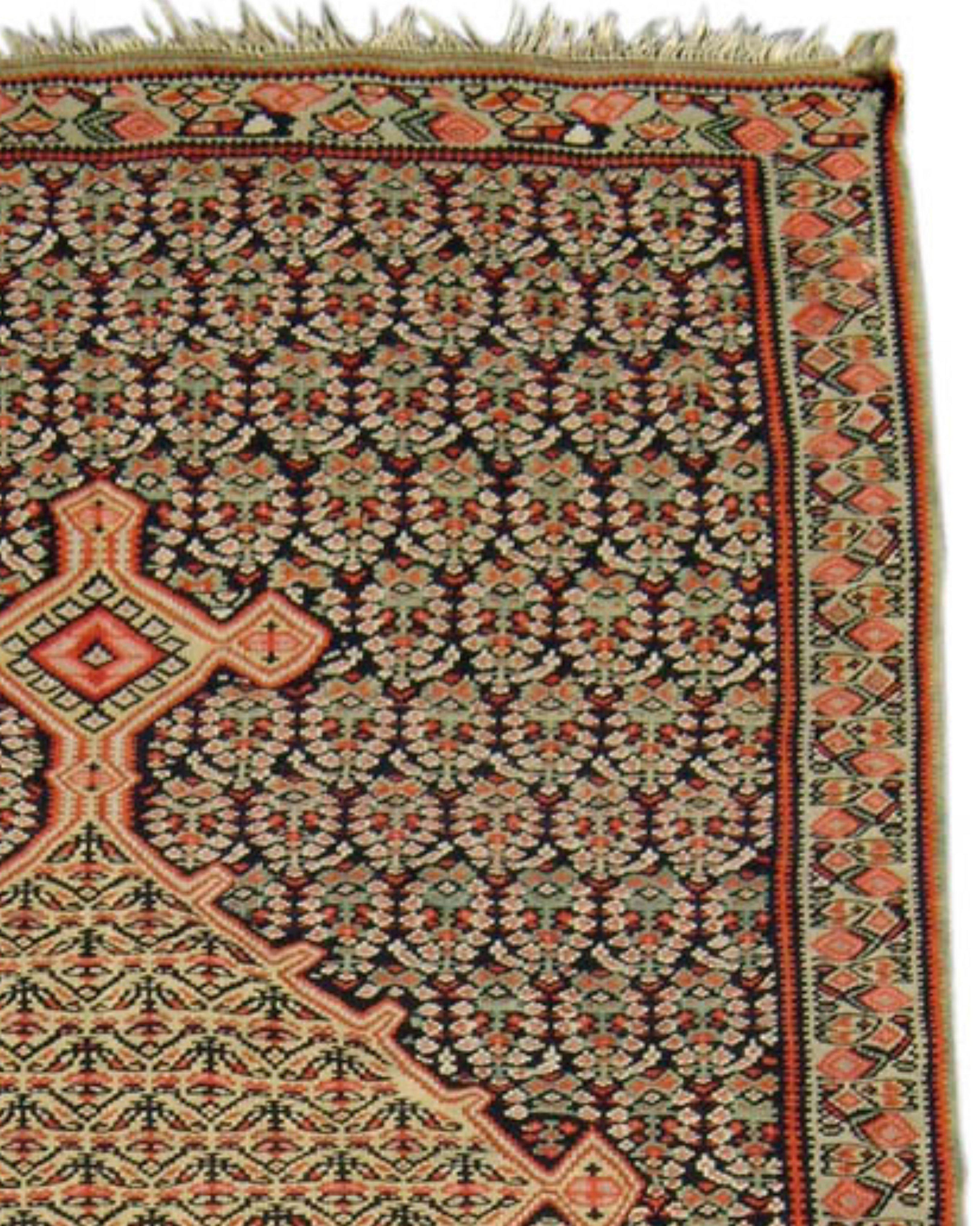 Antique Persian Senneh Kilim Rug, 19th Century

A central medallion in the classic Persian style floats against a ground of delicately stylized paisleys or “boteh” in this elegant Senneh kilim from western Persia. A further floral design gracefully