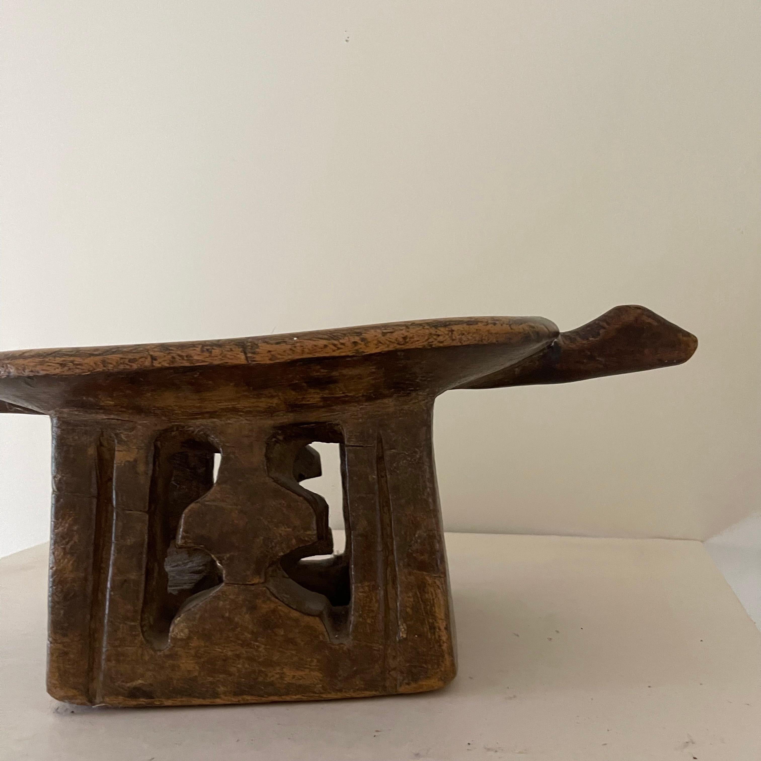Senufo wooden hut stool, foot carved with a cross. Early 20th Century.