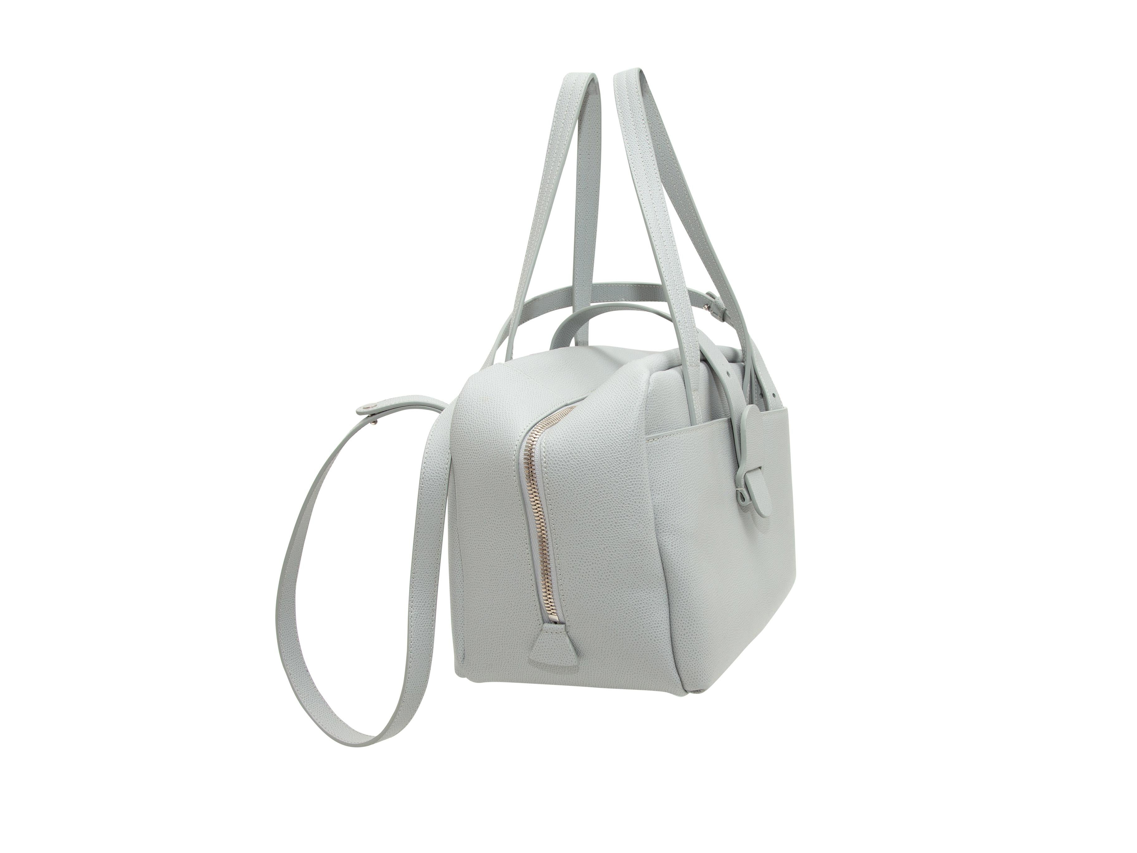 Product details: Light grey leather Maestra bag by Senreve. Silver-tone hardware. Dual flat handles. Single shoulder strap. Zip closure at top. 17