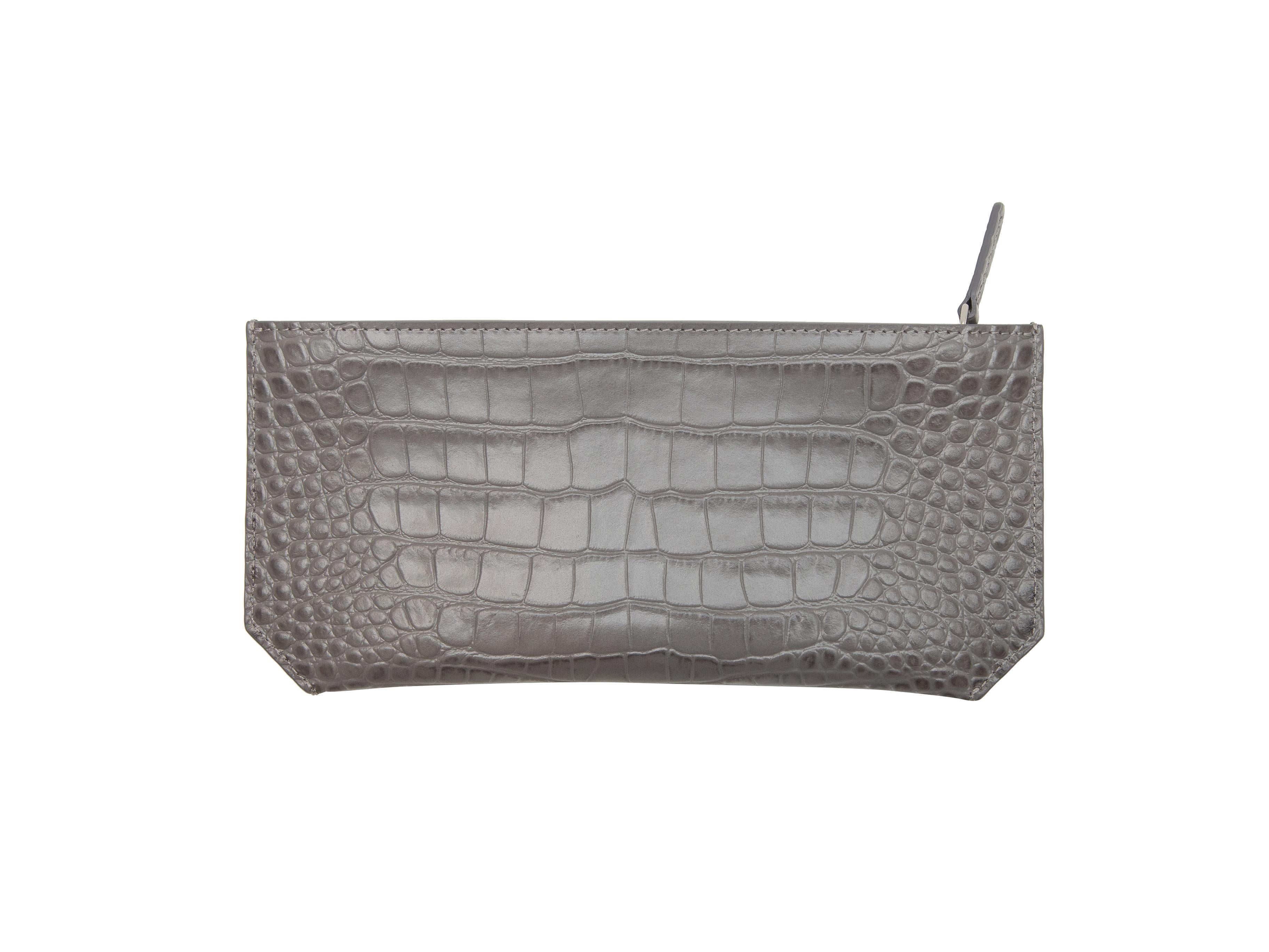 Product details: Storm grey 'Dragon' embossed leather Bracelet Pouch by Senreve. Silver-tone hardware. Zip closure at top. 4.75